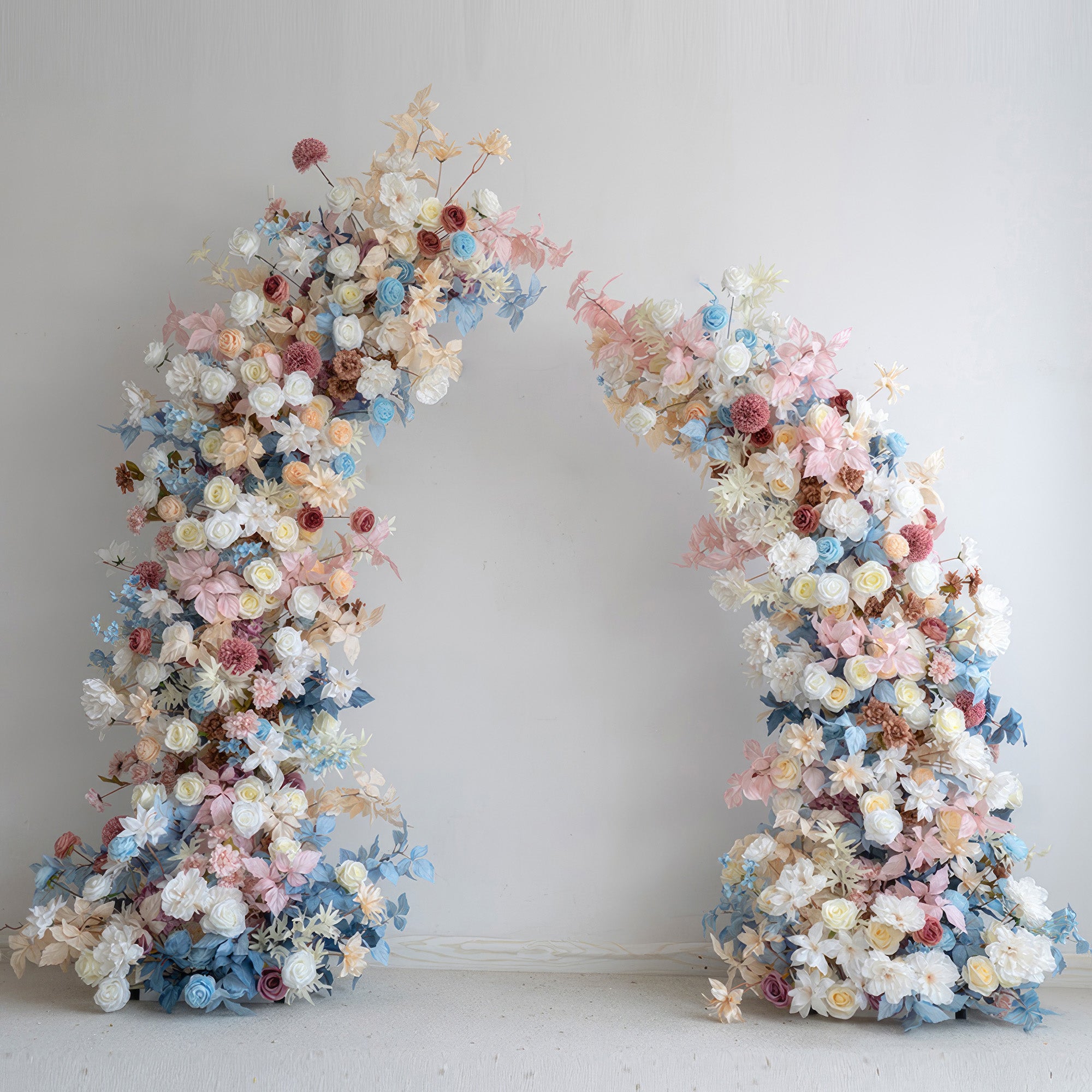 This flower - covered arch showcases a pastel symphony of soft blues, pinks, whites, and warm earthy tones. It combines roses, dahlias, and other blossoms, creating a romantic and dreamy style. Ideal for weddings, events, and photoshoots to add a touch of charm.