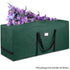 This image shows a large, dark green storage bag with black handles and a rectangular label patch on its side. The bag appears to be made of a durable fabric, likely for carrying or storing items. At the top of the bag, there is a display of colorful artificial flowers in various shades of purple and pink. Notably, a caption at the bottom indicates that “The package item excludes the flowers,” clarifying that the flowers are not part of what is being sold.