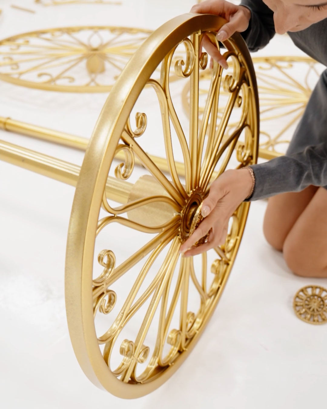 Gold decorative wheel with intricate design on a white background