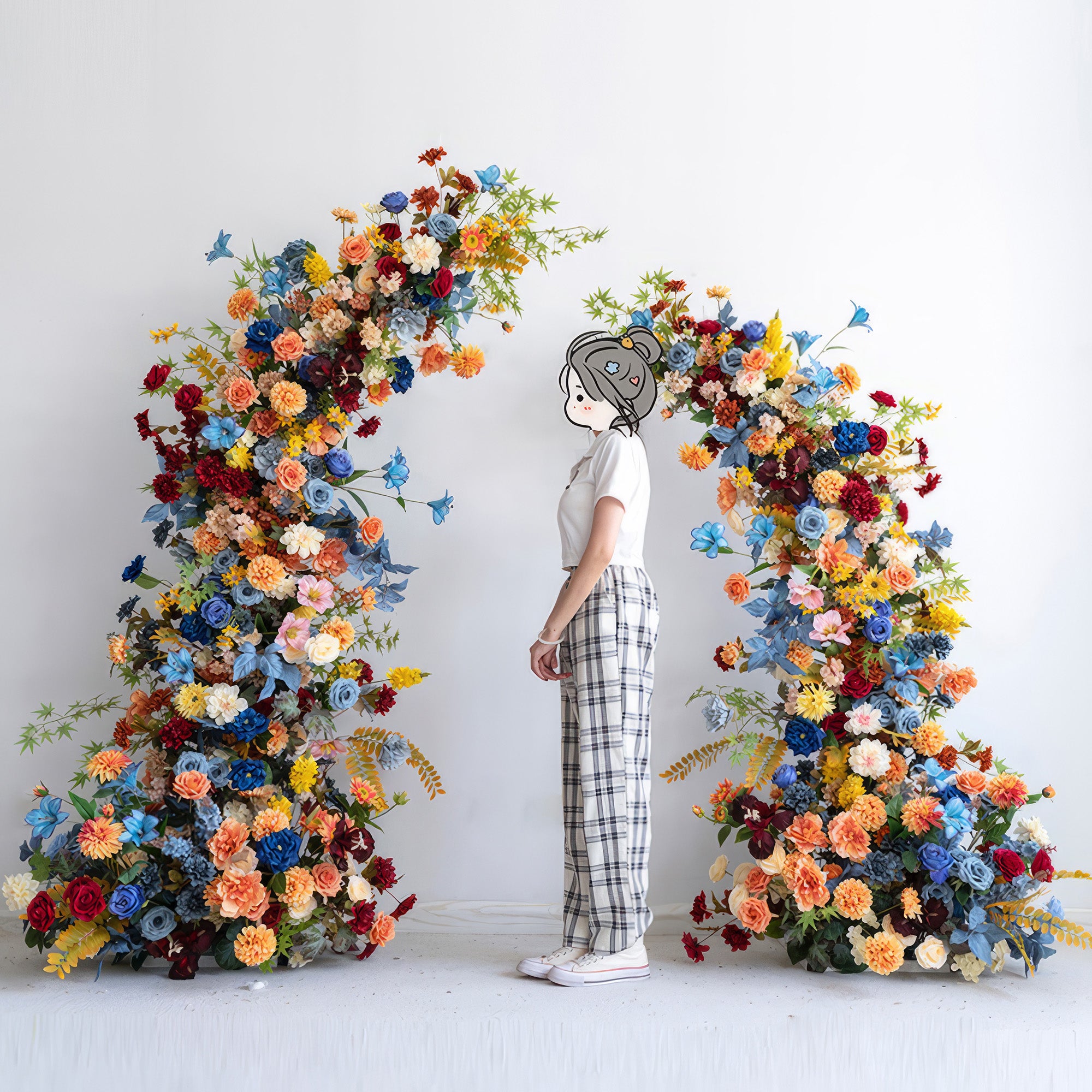 The image shows a person standing before a floral arch. Colors are a vibrant mix of blue, orange, red, yellow and pastel hues. Styles include roses and daisies. The overall look is lively and celebratory.
