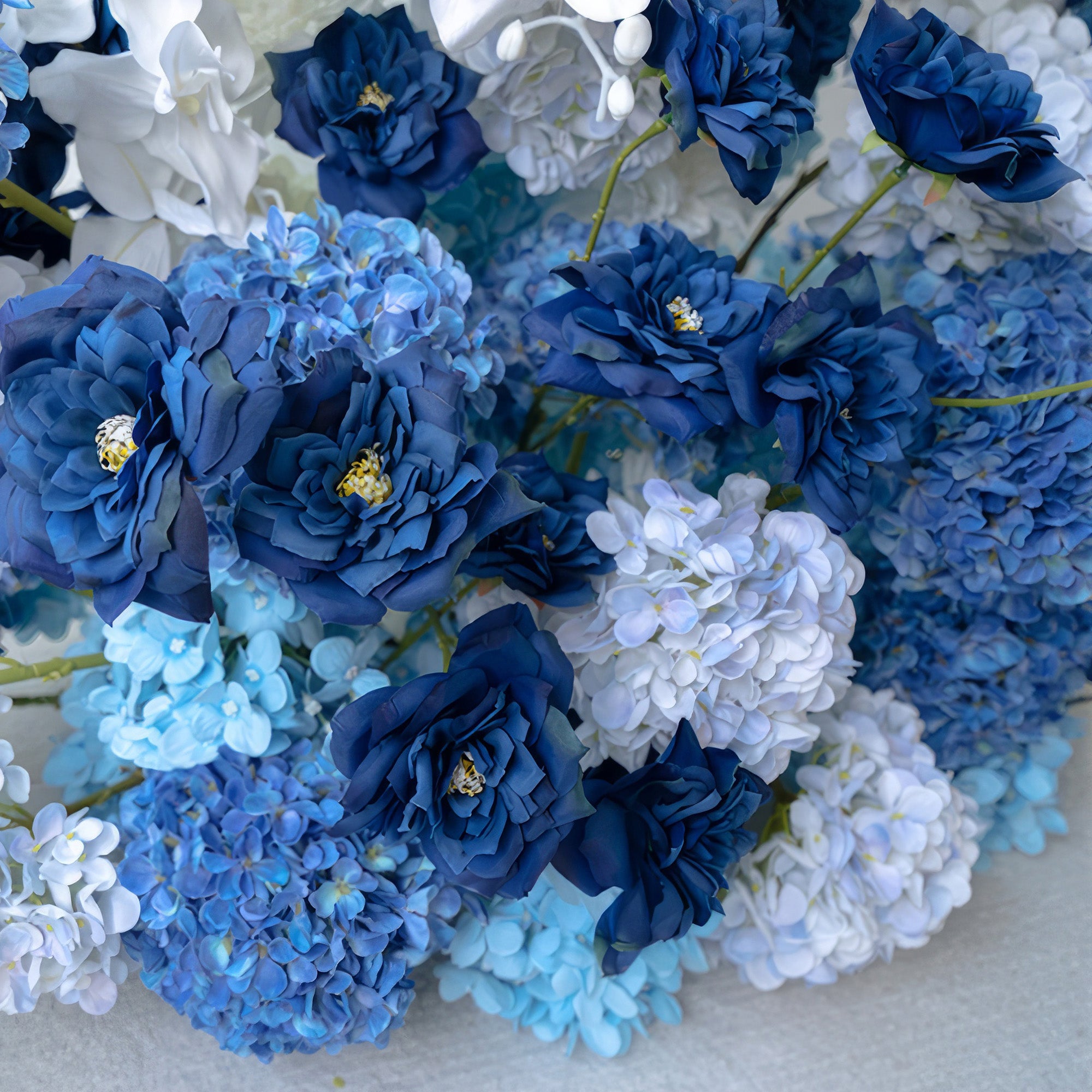 This floral cluster features a stunning array of blues and whites. Deep blue roses stand out among light and medium - blue hydrangeas. The color combination offers a calm, elegant style, perfect for adding a touch of sophistication to weddings, events, or interior decor.
