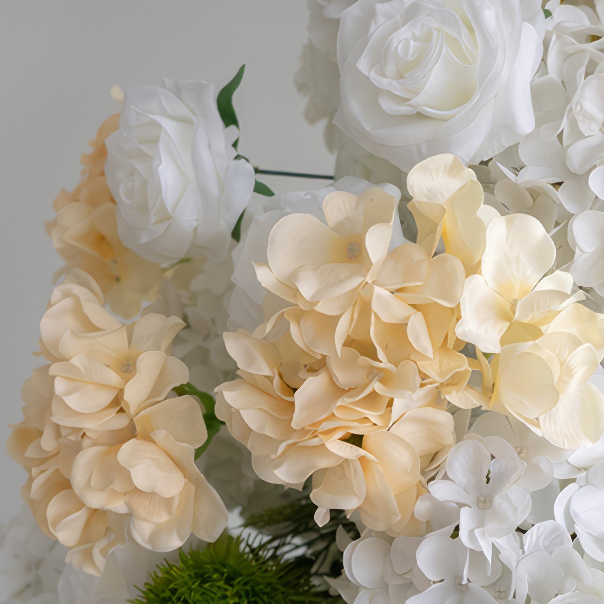 This image features an arrangement of artificial flowers. The color palette consists of soft white, creamy beige, and a touch of green. It includes white roses and clusters of hydrangea - like flowers in white and beige, presenting an elegant and gentle style.