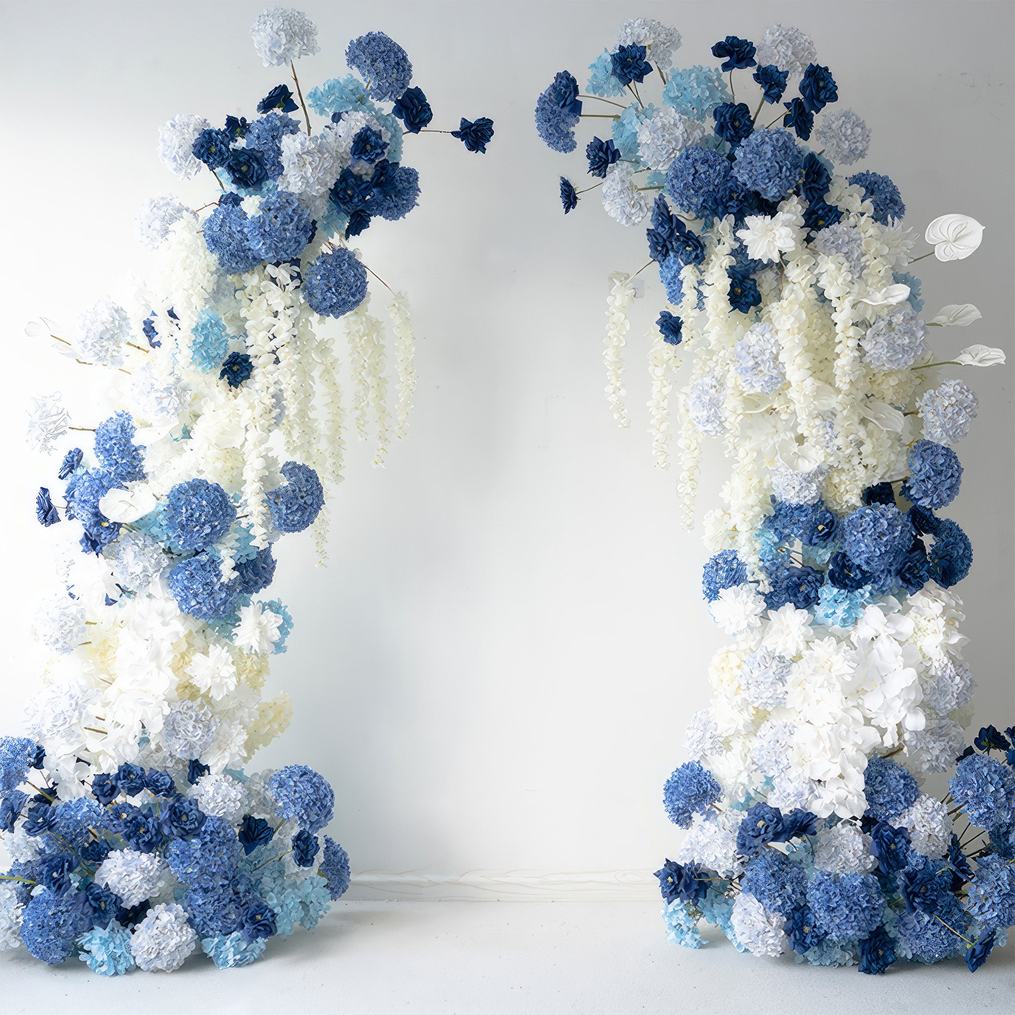 This floral arch is a captivating blend of deep and light blue hydrangeas, complemented by white blooms. Its cascading design exudes an elegant, serene style, making it perfect for weddings, events, or as a stunning backdrop for photo - taking.