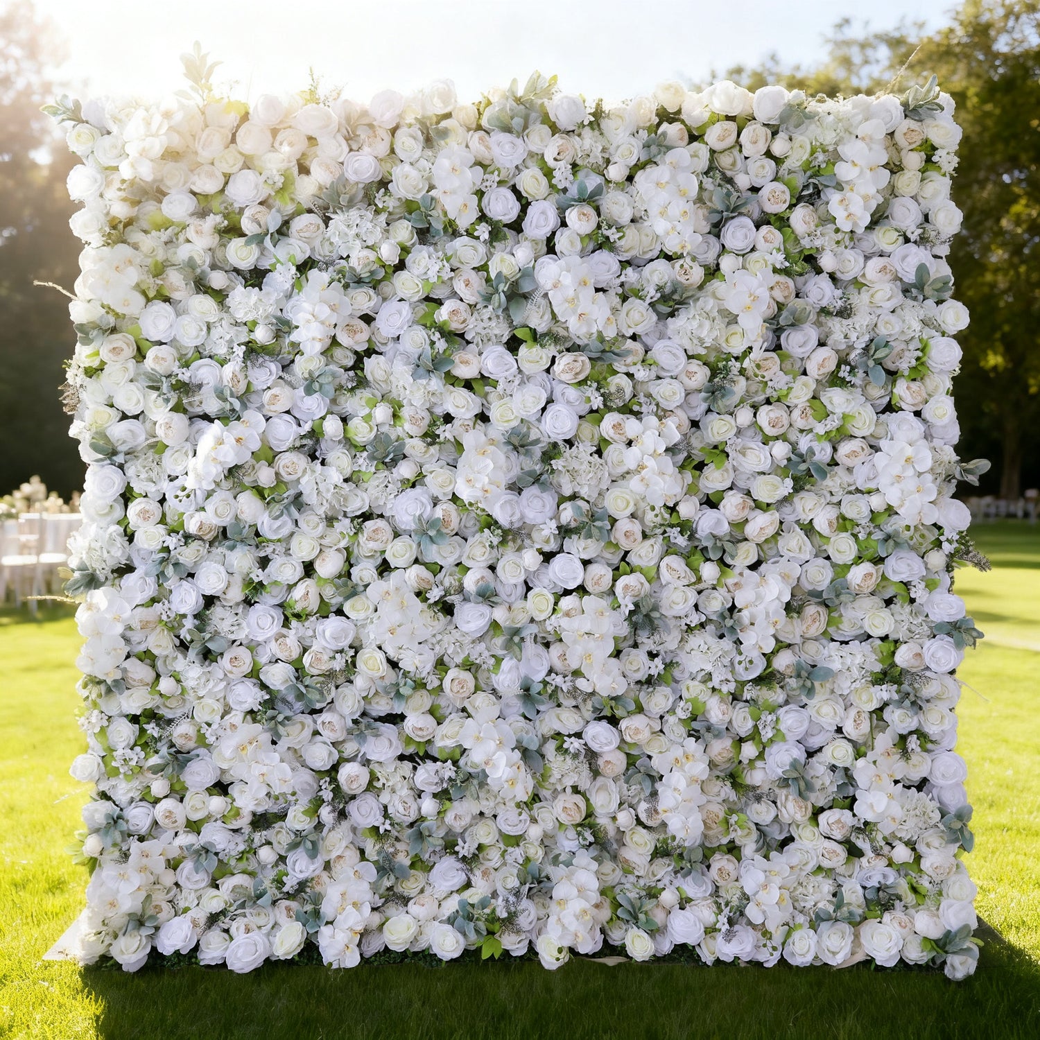 This image showcases a stunning floral wall by Valar Flowers, densely adorned with an array of white and light - hued roses and other blooms. Set outdoors on a lush green lawn with trees in the background, the vibrant arrangement exudes elegance and natural beauty, creating a picturesque and romantic atmosphere, perfect for special events or as a captivating decorative backdrop.