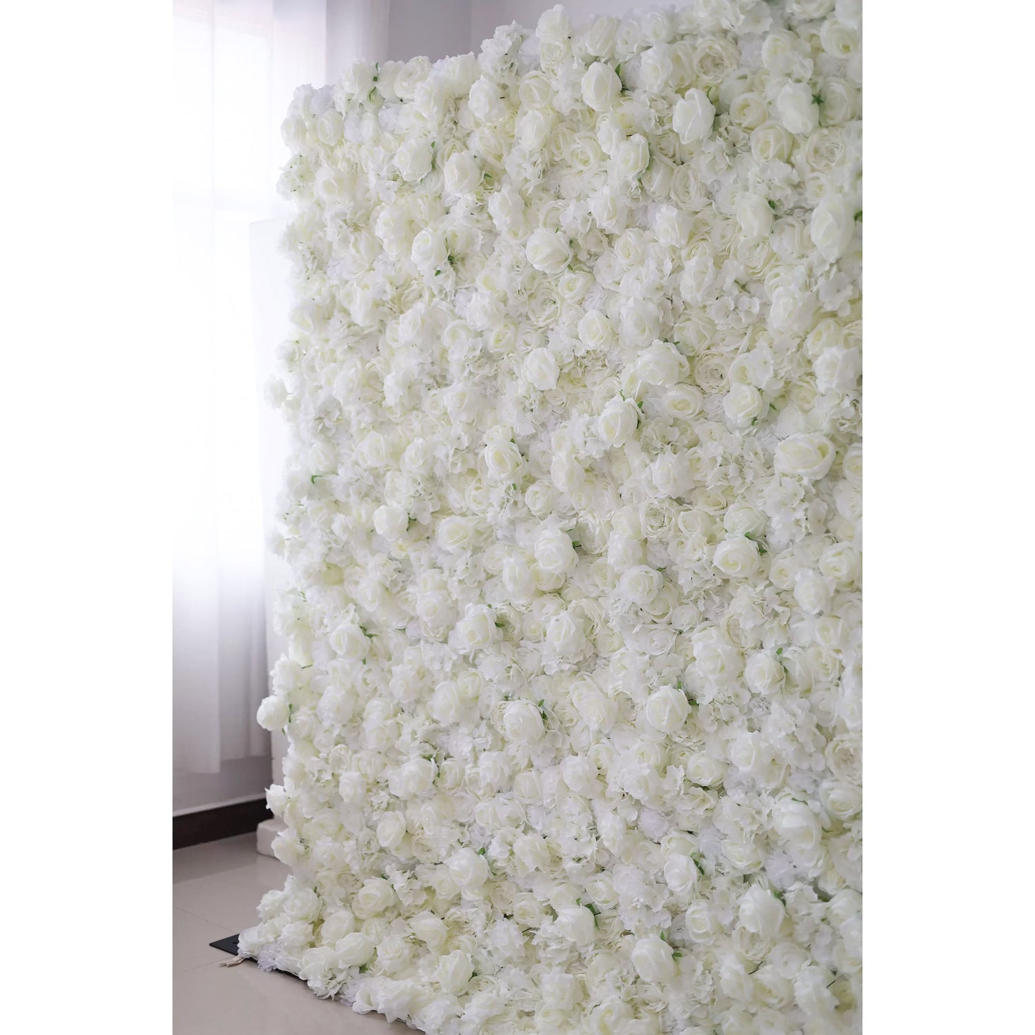 This photo features a stunning floral backdrop densely covered with artificial white roses and other white flowers. The intricate arrangement creates a visually captivating and elegant display, exuding purity and sophistication. Perfect for weddings, photo shoots, or special events, it adds natural beauty and charm to any setting. The all-white scheme enhances its timeless appeal.