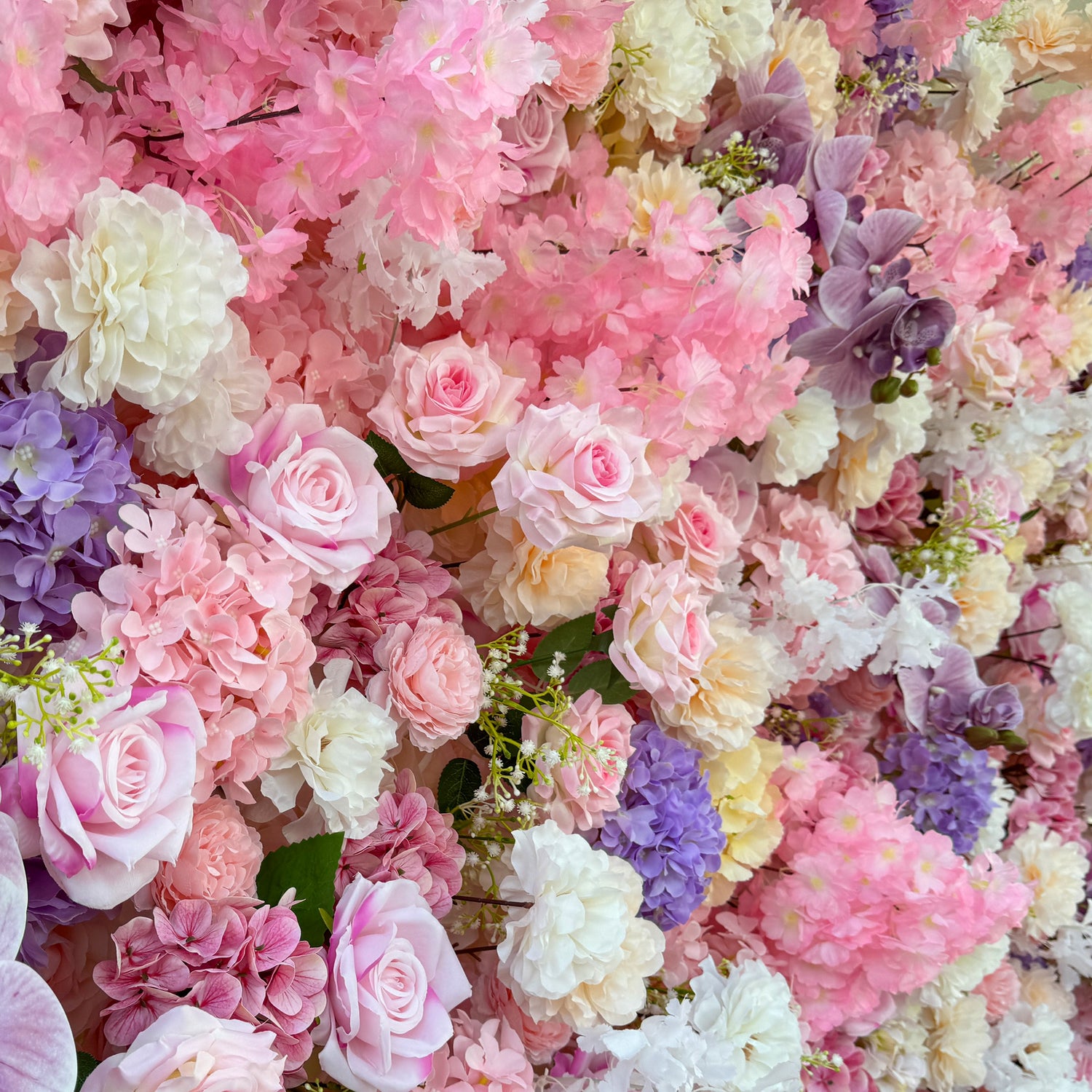 This photo from ValarFlowers showcases a lush floral arrangement. It features roses in soft pink and white hues, hydrangeas in shades of purple and pink, along with delicate white flowers and small green - stemmed blooms. The large purple orchids add an elegant touch. Ideal for weddings, bridal showers, or romantic events, this dreamy and colorful mix exudes charm and sophistication.