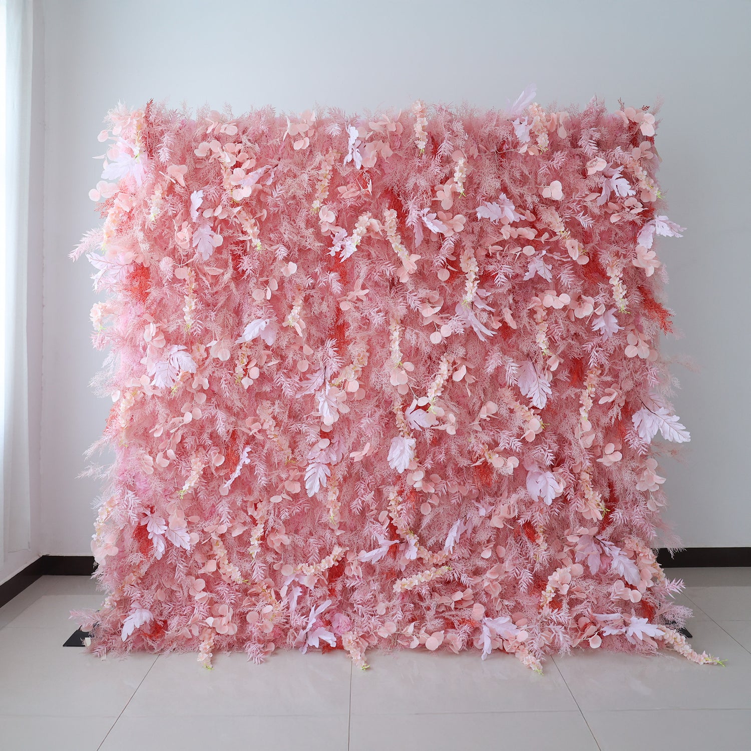 This image showcases a large, dense floral wall indoors. It&