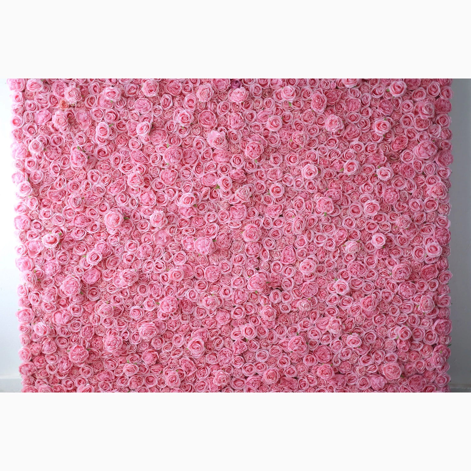 A vast artificial flower wall features a dense arrangement of uniform pink roses. Each bloom is tightly clustered, creating a smooth, lush, and romantic texture. The consistent soft - pink hue exudes a gentle, elegant, and dreamy vibe, perfect for adding a sweet, charming touch to decor or event backdrops.