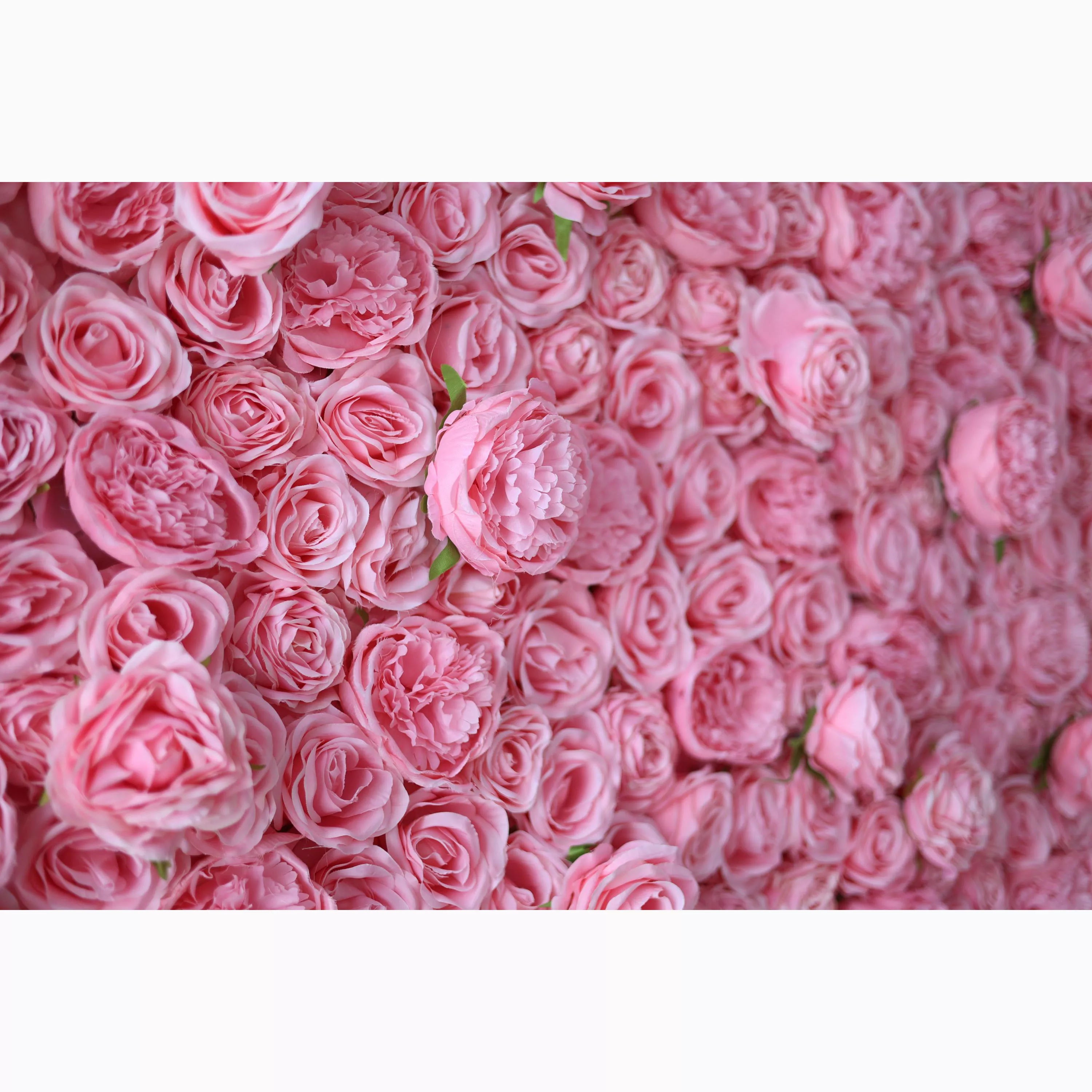 A dense wall of artificial pink roses and peonies. The soft, uniform pink hue creates a lush, romantic texture. Varied petal layers add depth, with small green leaves peeking through. Perfect for adding an elegant, dreamy vibe to decor or events.