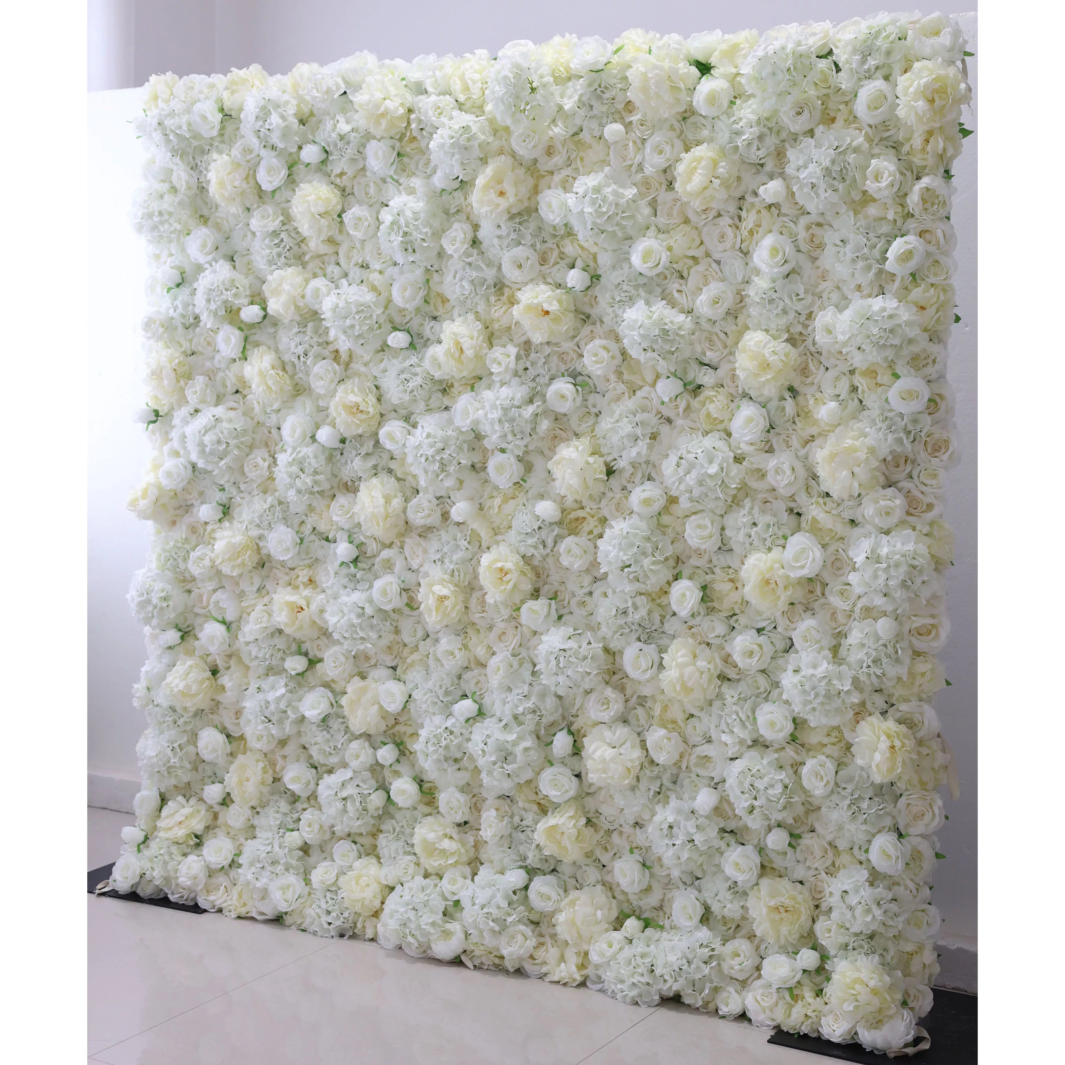 A large artificial flower wall featuring a dense arrangement of champagne, ivory, white, and grey flowers, suitable as a backdrop for events.