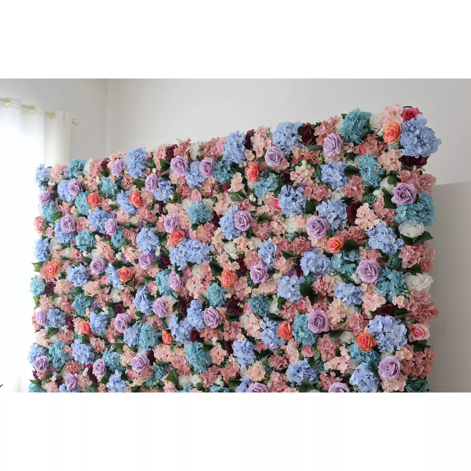 This large artificial flower wall showcases a lush blend of blue hydrangeas, purple roses, peach blooms, and greenery. The dense, vibrant arrangement creates a romantic, eye - catching display, perfect for event backdrops, adding an elegant, dreamy charm to the space.