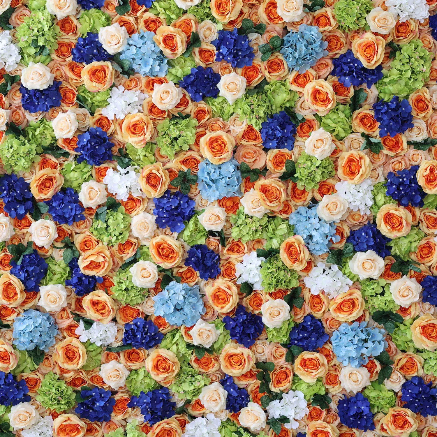 This close - up features a lush artificial flower wall. It blends orange roses, blue hydrangeas, white blooms, and green foliage. The dense, varied arrangement creates a vibrant, textured display, evoking a cheerful, lively vibe. Ideal for event backdrops, it adds an eye - catching, decorative charm with its harmonious color mix.