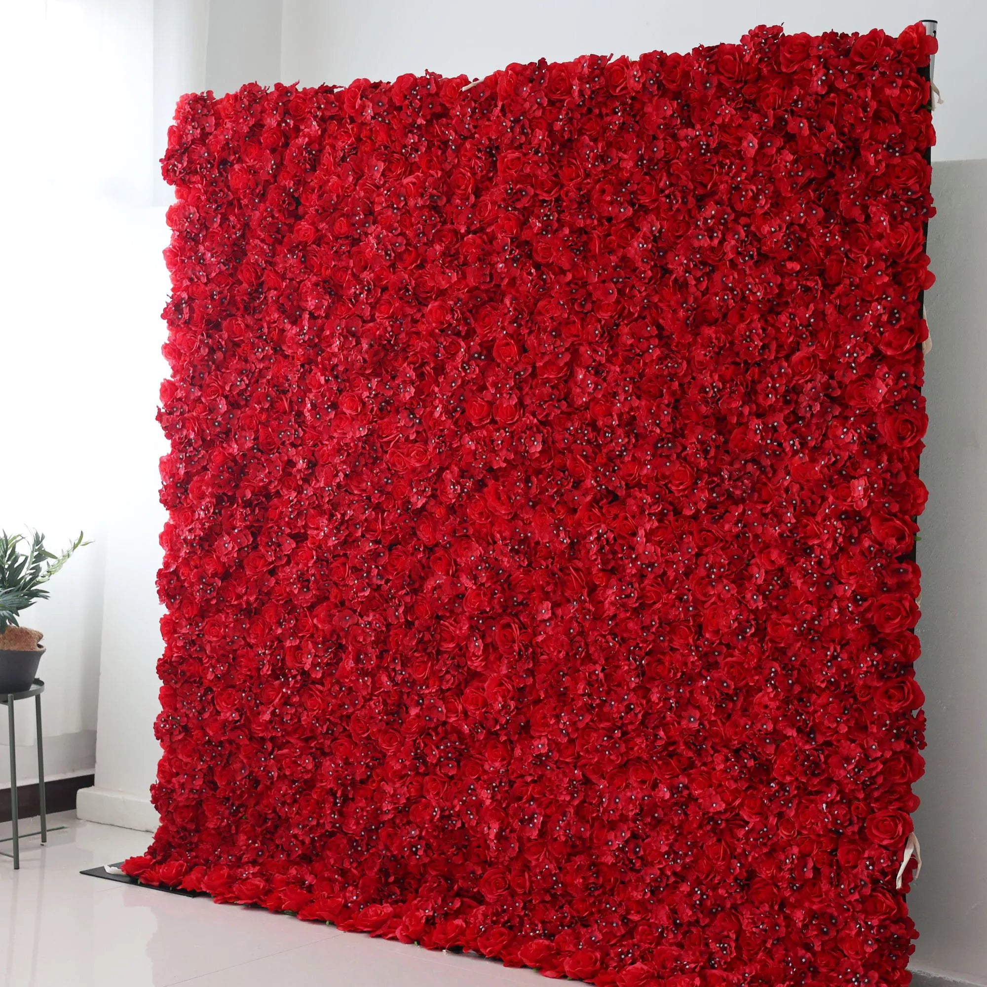 Valar Flowers Roll Up Backdrop: This is a large artificial flower wall, fully covered with dense, vibrant red roses. The uniform arrangement creates a bold, passionate, and elegant look. It serves as a striking backdrop, ideal for adding a touch of drama and romance to events like weddings, photo shoots, or special celebrations.