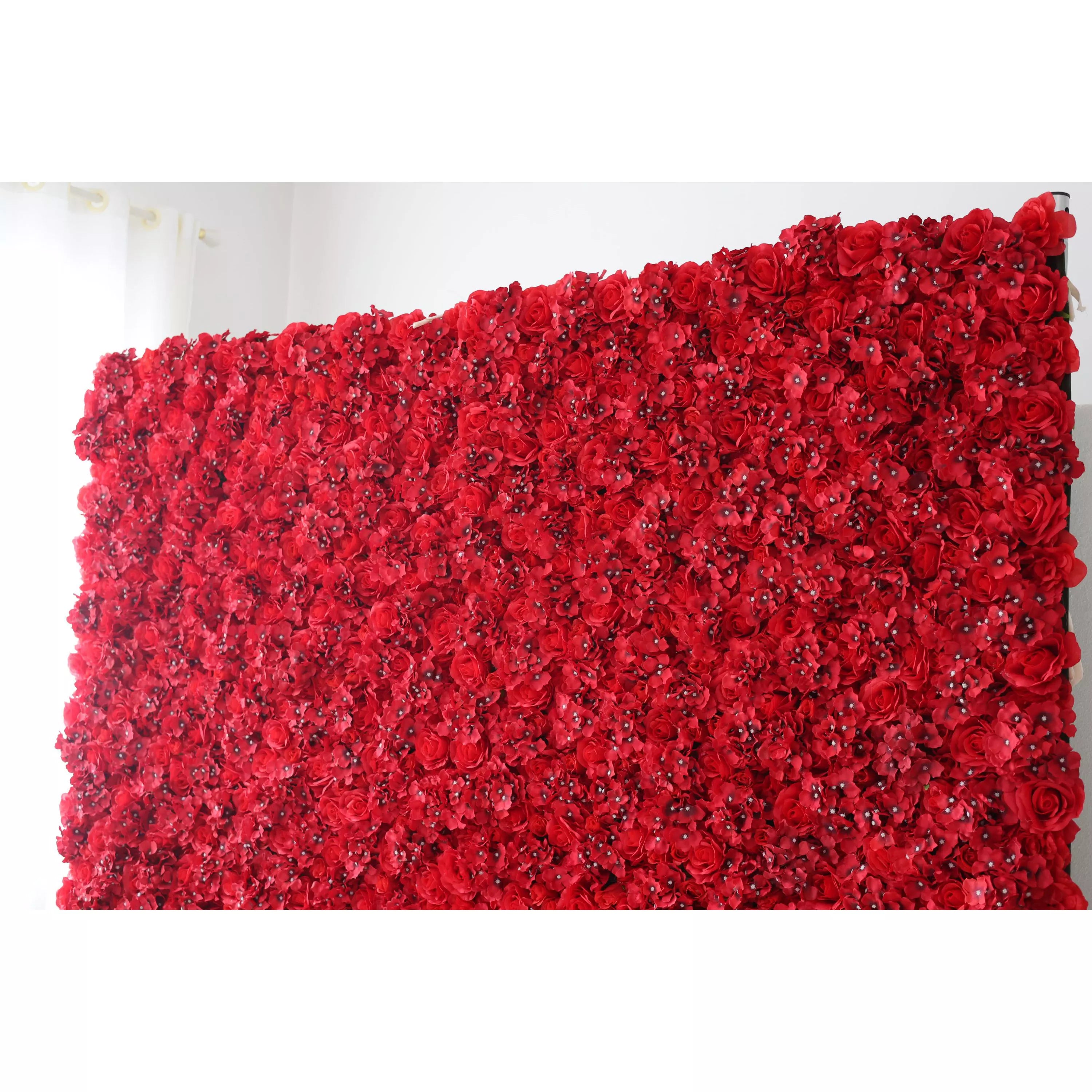 This is a large artificial flower wall, densely covered with vibrant red roses and small blossoms. The uniform, lush arrangement creates a bold, passionate, and elegant visual. It serves as a striking backdrop, ideal for adding drama and romance to events like weddings, photo shoots, or special celebrations, enhancing the atmosphere with its rich color and intricate floral design.