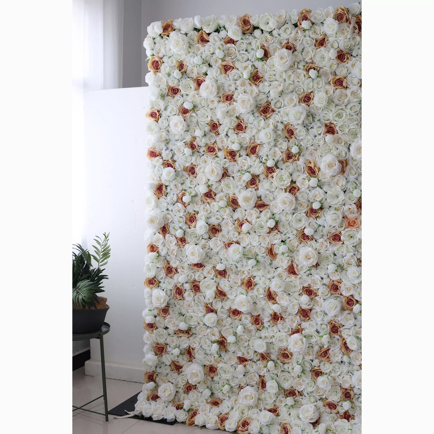A large artificial flower wall features a dense arrangement of white roses, each with a delicate brown - edged center. The uniform, lush blooms create a sophisticated, elegant backdrop, perfect for adding a touch of romance and refinement to events or decor.
