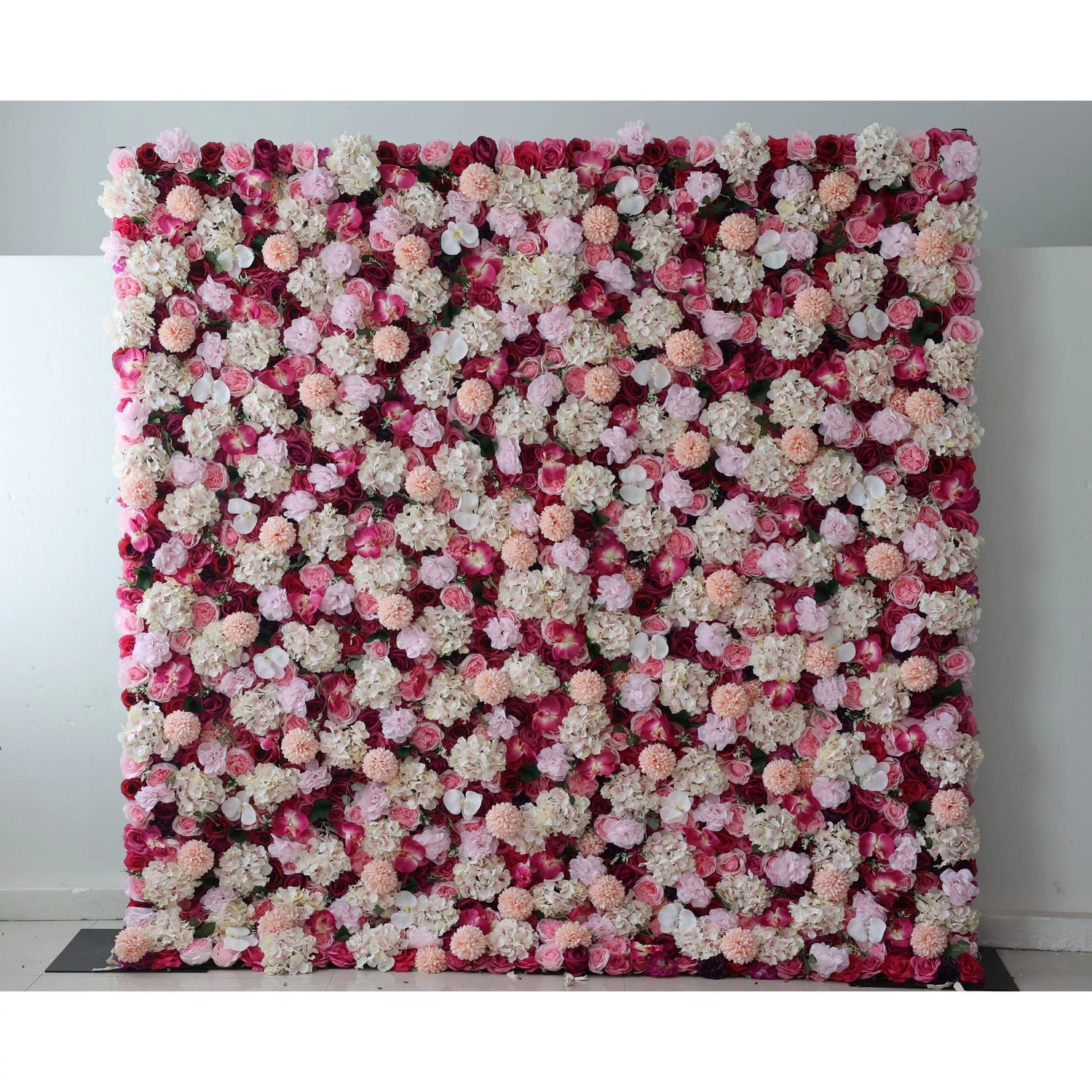 Valar Flowers: This large artificial flower wall features a rich mix of blooms. Red blossoms form the base, adorned with white hydrangeas, pink roses, peach - colored carnations, and small white flowers. The dense, colorful arrangement creates a vibrant, romantic backdrop, ideal for weddings or events, adding an elegant and decorative touch.