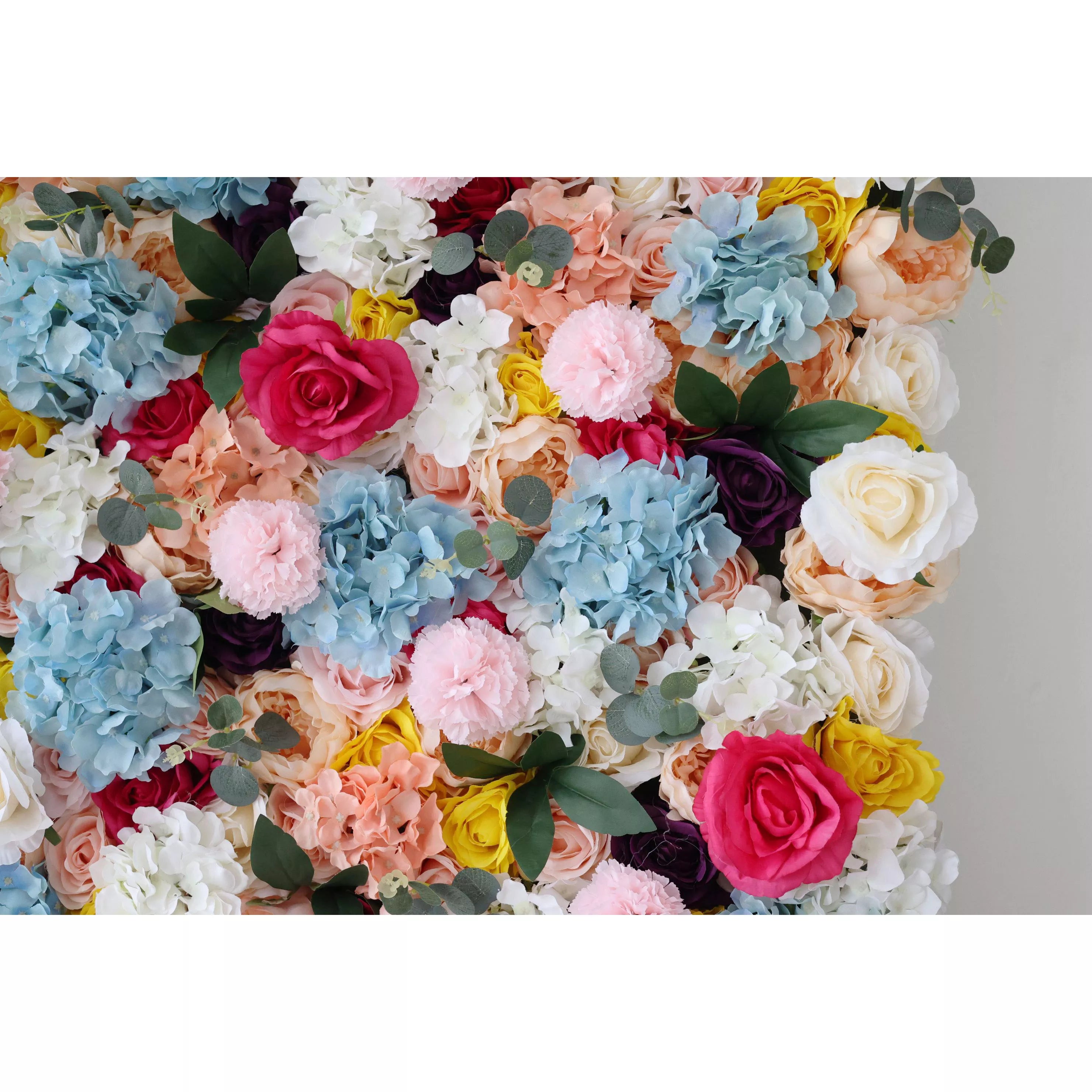 This is a vibrant artificial flower wall, densely packed with an array of colorful blooms. There are blue hydrangeas, red roses, white blossoms, along with soft - hued pink and peach flowers. Interspersed with green leaves, the wall creates a lively and eye - catching display. Ideal for event backdrops, it adds a cheerful and festive atmosphere to any occasion, such as weddings or parties.