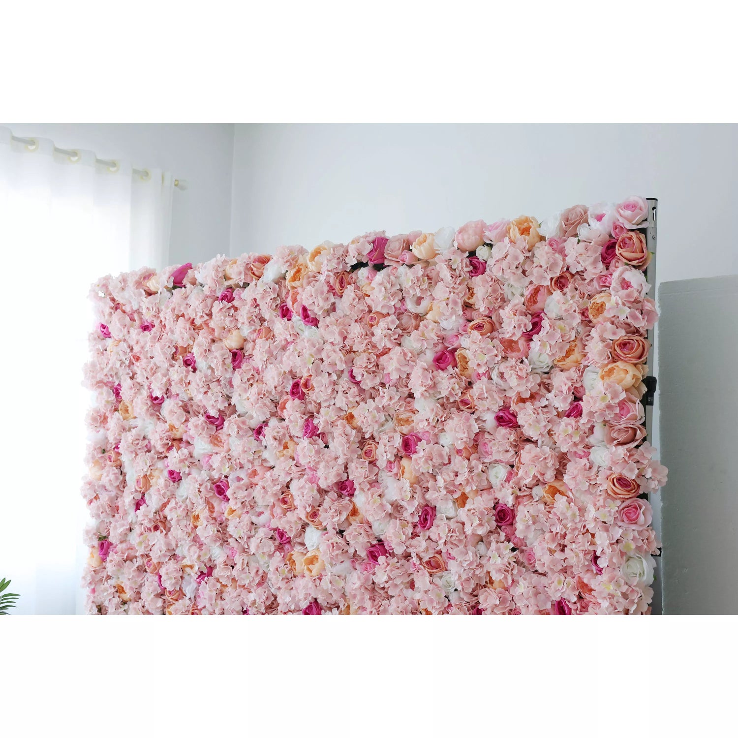 This is a large, elegant flower wall filled with artificial blooms. Soft pink hydrangeas, peach - colored roses, and hints of deeper pink flowers create a romantic, dreamy texture. The dense arrangement and gentle color palette make it perfect for weddings or photo backdrops, exuding charm and warmth.