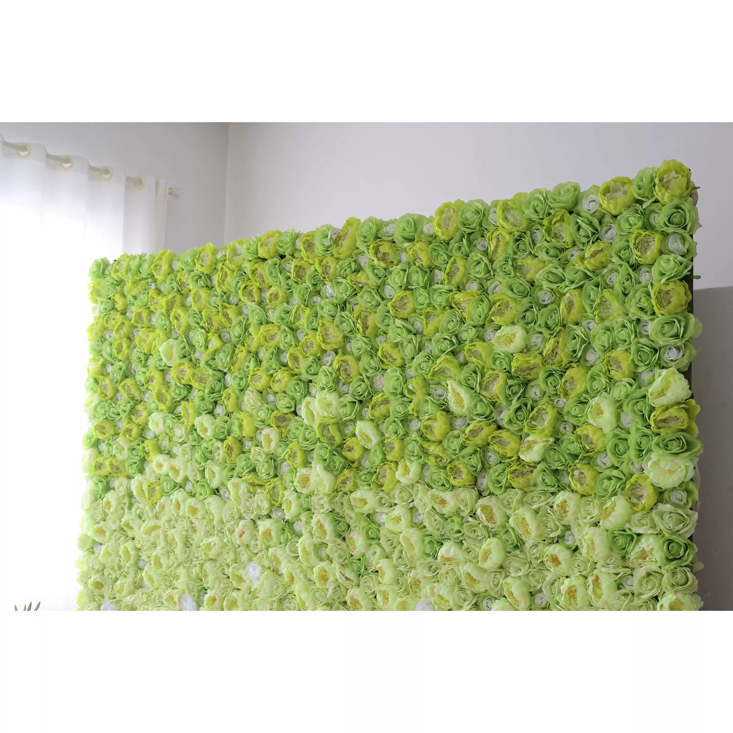 This is a large - scale artificial flower wall, densely covered with green roses in gradient shades from light to dark. It serves as a decorative backdrop, likely for events like weddings or photo - shoots, creating a fresh and vibrant atmosphere.