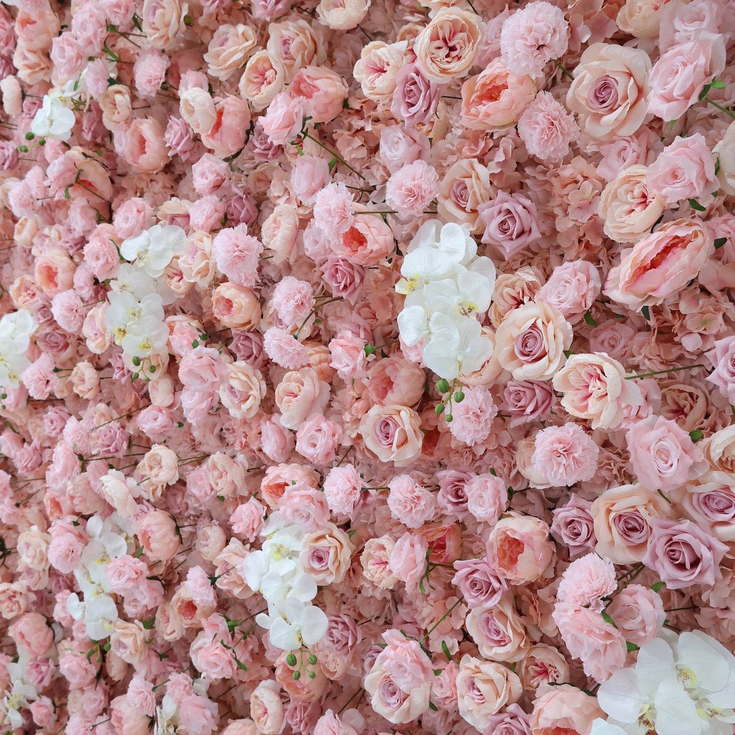 This image showcases a beautiful floral arrangement by Valar Flowers. It features a dense cluster of artificial flowers in soft, romantic shades of pink and white. The blooms, including roses and other complementary flowers, are intricately arranged to create a lush, textured, and visually appealing display. Perfect for adding a touch of elegance and charm to events or spaces, the arrangement exudes a delicate and sophisticated atmosphere.