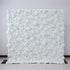 A large, dense wall of artificial white flowers fills the frame. Various white blooms, including roses and other floral types, create a lush, continuous expanse. Set against a plain light - colored wall with a tiled floor, it exudes elegance and purity, ideal for events like weddings or photo backdrops.