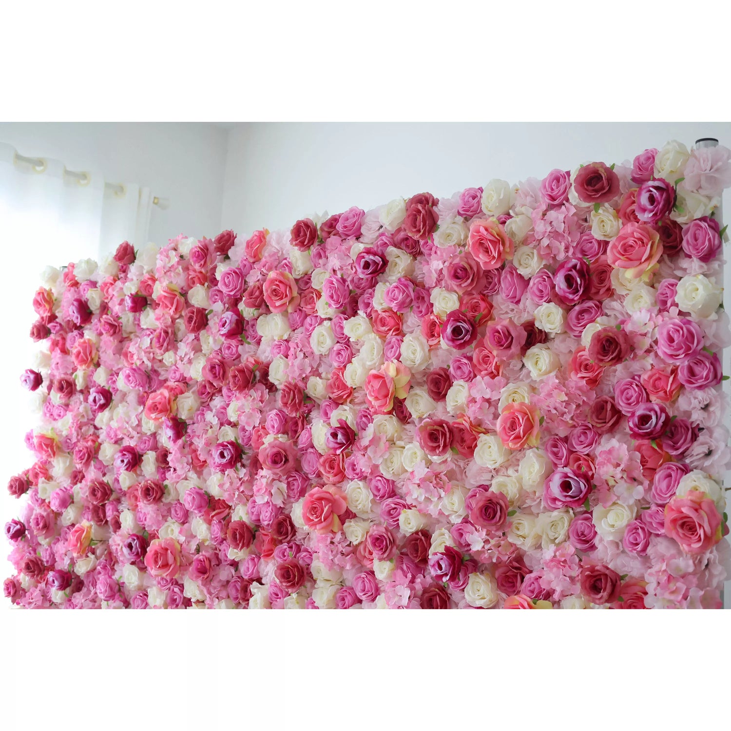 This flower wall is a vibrant tapestry of artificial roses in pink, white, and purple. Dense, overlapping blooms create a lush, romantic texture. Subtle color gradients and varied petal shapes add depth, making it perfect for weddings or events. It exudes elegance, offering a captivating backdrop for photos and decor.