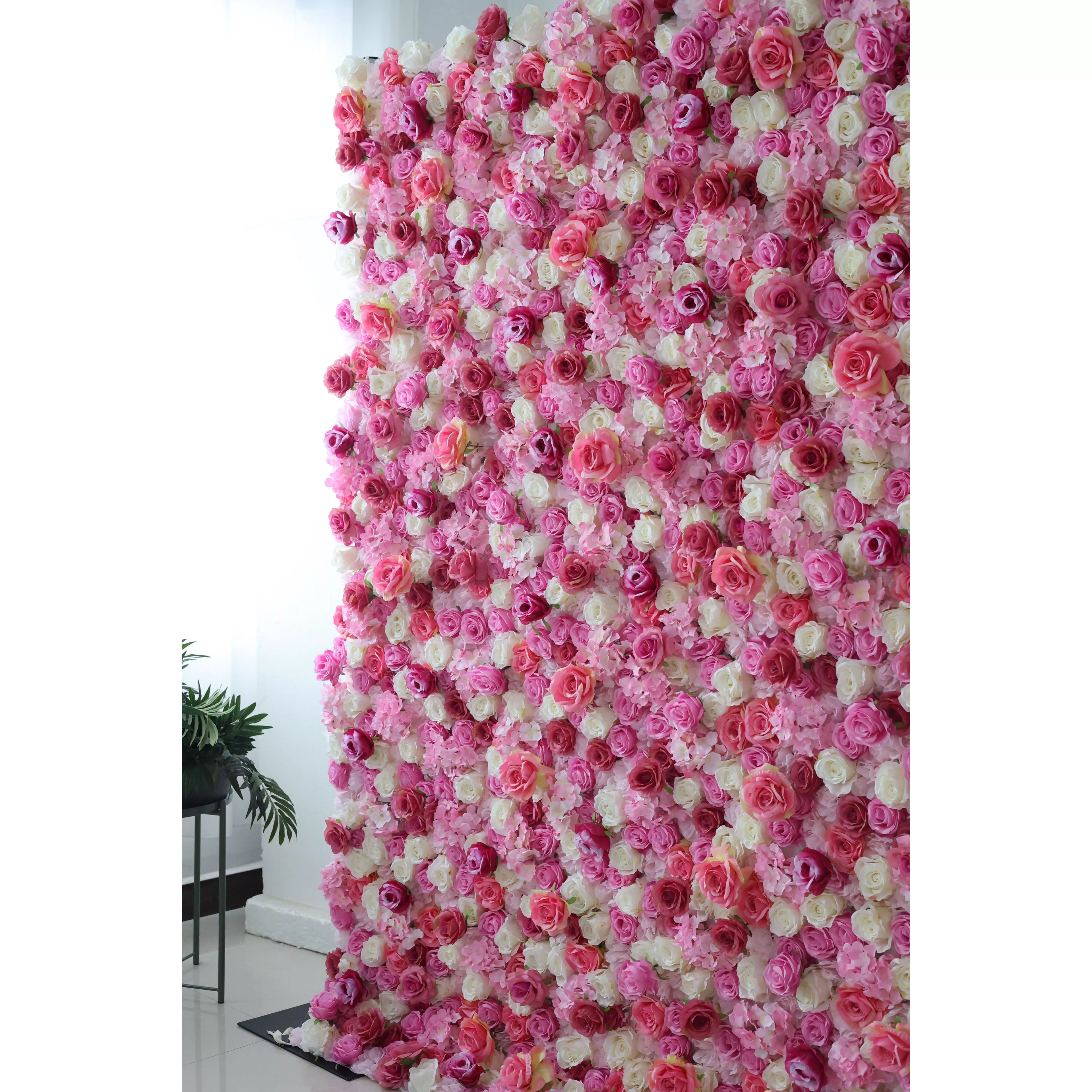This flower wall is a stunning blend of pink, white, and purple artificial roses. Dense, overlapping blooms create a lush, romantic texture. Subtle color gradients and varied petal shapes add depth, making it perfect for weddings or events. It exudes elegance, offering a captivating backdrop for photos and decor.