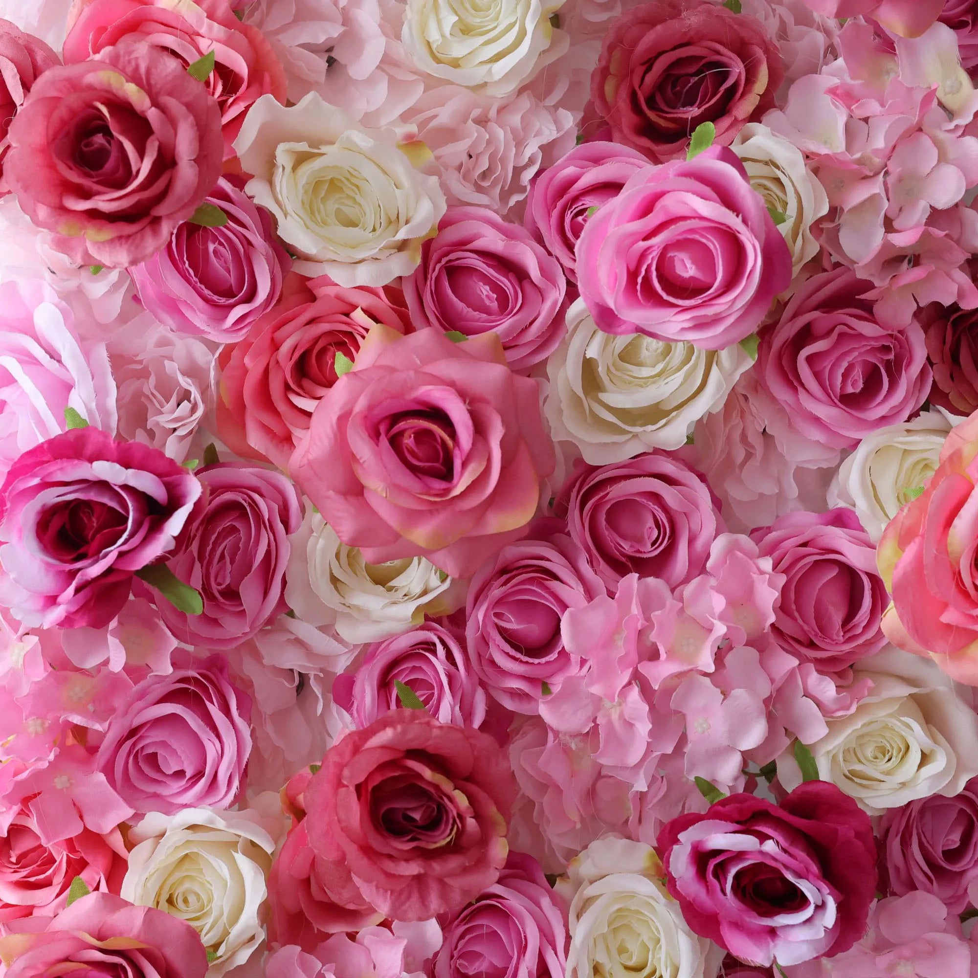 This flower wall features a lush arrangement of artificial roses in soft pink, white, and deep rose hues. Dense, overlapping blooms create a romantic, textured backdrop. Subtle color gradients and varied petal shapes add depth, making it ideal for weddings or events. It exudes elegance and charm, perfect for photos and decor.