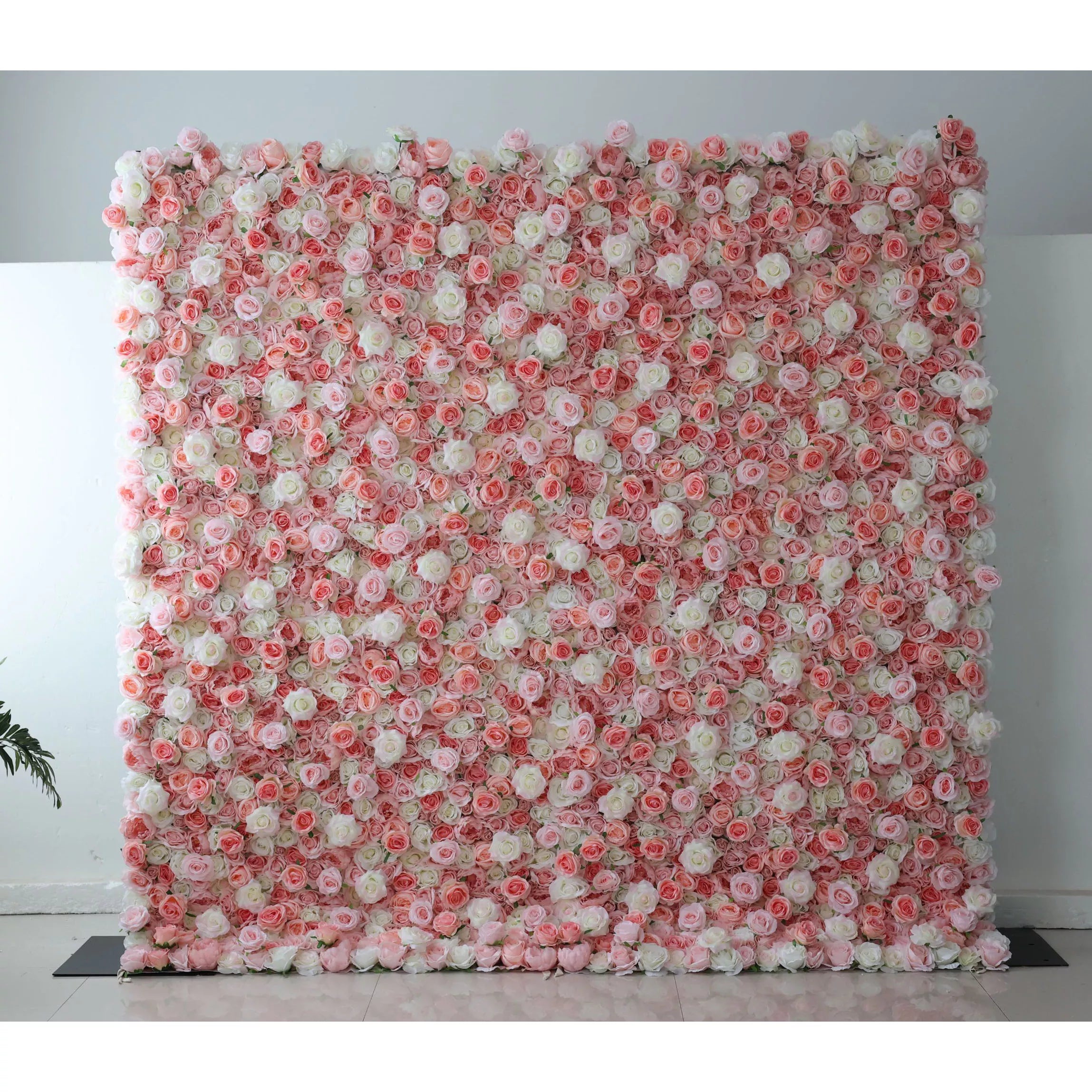 This flower wall is a beautiful blend of pink and white artificial roses. The gradient arrangement creates a soft, romantic vibe, with dense blooms forming a textured, dreamy backdrop. Perfect for weddings or events, it exudes elegance and charm, offering a lovely setting for photos and decor.
