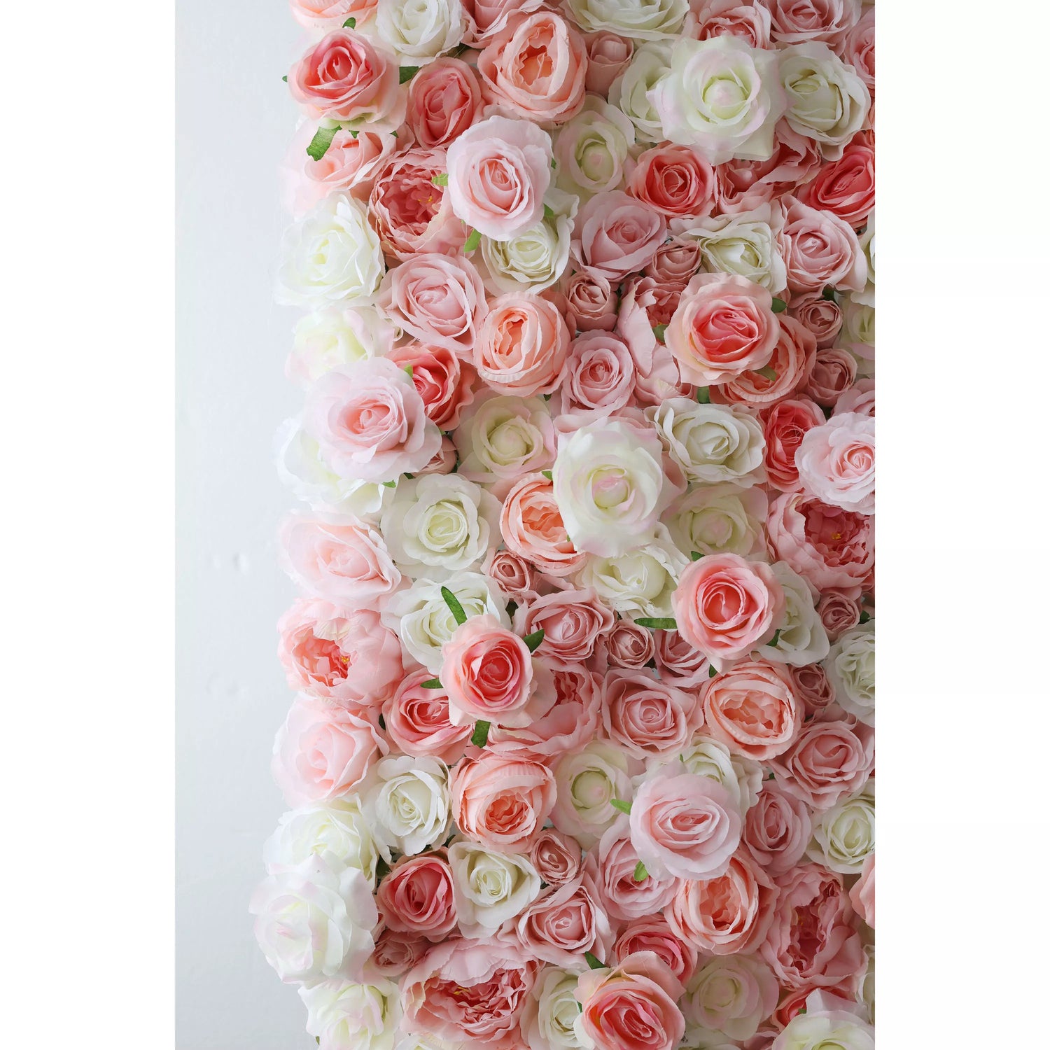 This flower wall showcases a delicate mix of pink and white artificial roses. The blooms are densely packed, with varying petal tones creating a soft, romantic gradient. Small green leaves add subtle contrast, making it perfect for weddings or events. It exudes elegance and charm as a dreamy backdrop.