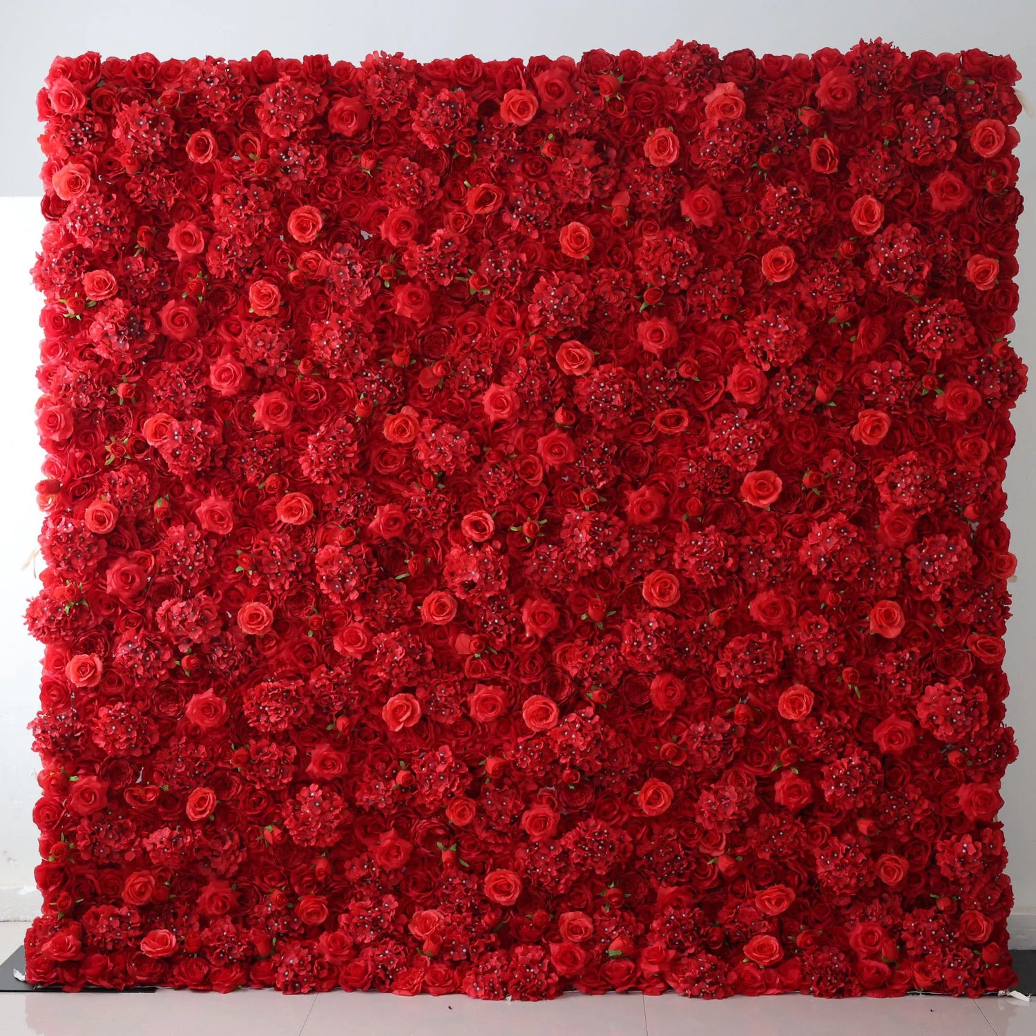 This flower wall is a bold, dense display of artificial red blooms. It combines roses and clustered flowers, creating a rich, vibrant texture. Perfect for events like weddings or celebrations, the deep red hue exudes passion and elegance, serving as a striking, eye - catching backdrop.