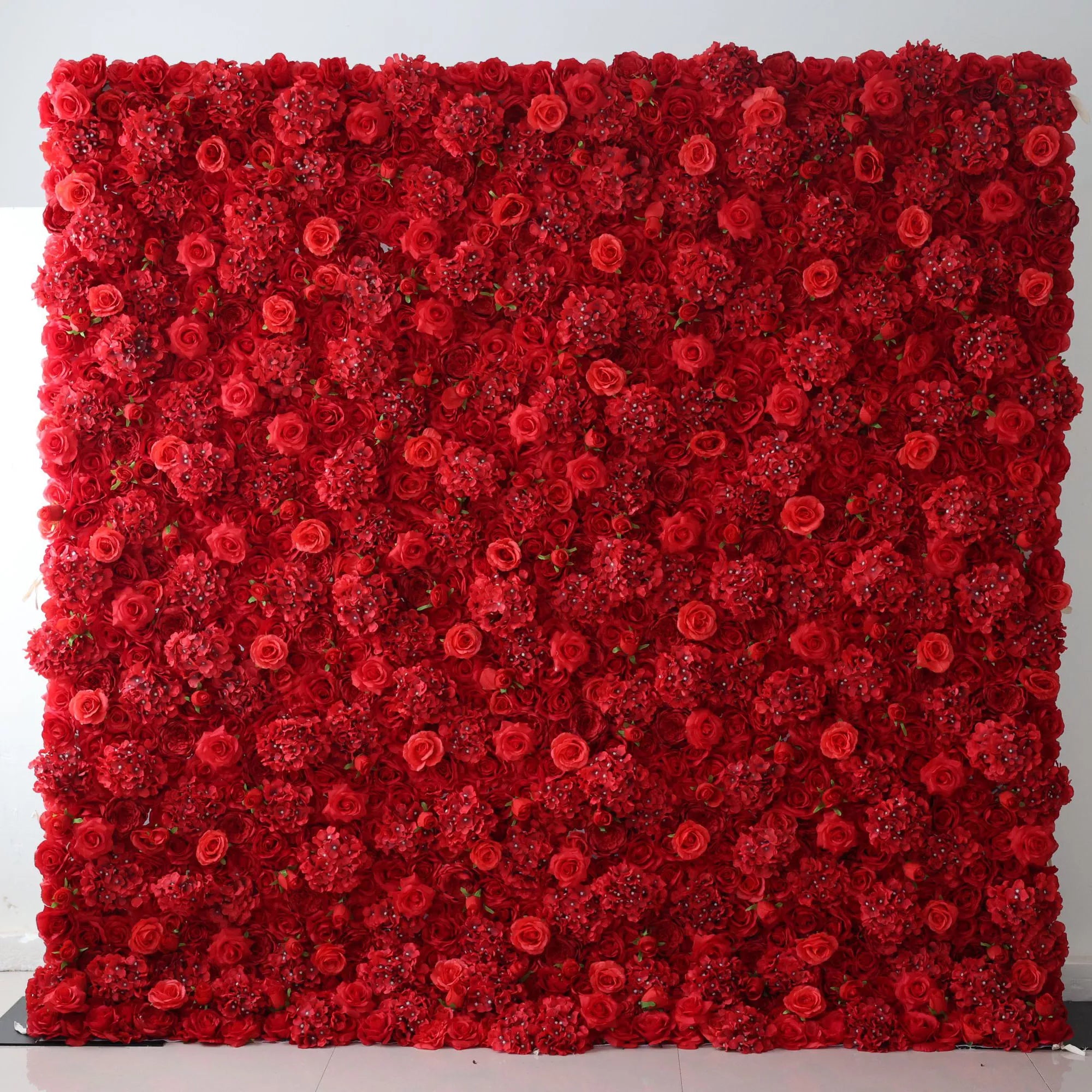 This flower wall is a bold, dense display of artificial red blooms. It combines roses and clustered flowers, creating a rich, vibrant texture. Perfect for events like weddings or celebrations, the deep red hue exudes passion and elegance, serving as a striking, eye - catching backdrop.