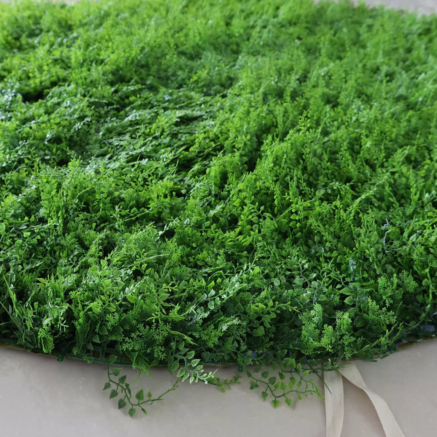 This image showcases a dense artificial greenery piece by Valar Flowers. It features a variety of textured green foliage, creating a rich, natural, and visually refreshing display. With attached straps for easy handling, this product is perfect for adding a touch of organic elegance to events or spaces, exuding a serene and sophisticated atmosphere characteristic of Valar Flowers’ craftsmanship.