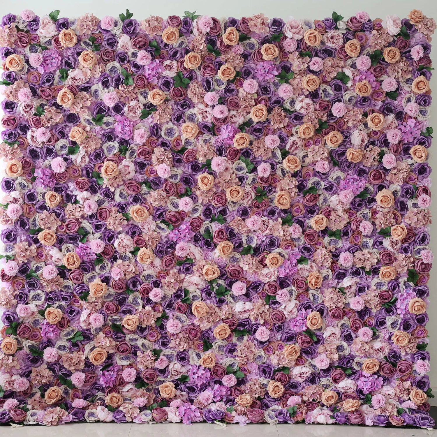 This flower wall is a dense, vibrant arrangement of artificial flowers. It features a harmonious mix of purple, pink, and peach - colored blooms, creating a lush, romantic texture. Ideal for decorative backdrops at events like weddings, adding an elegant and charming ambiance.
