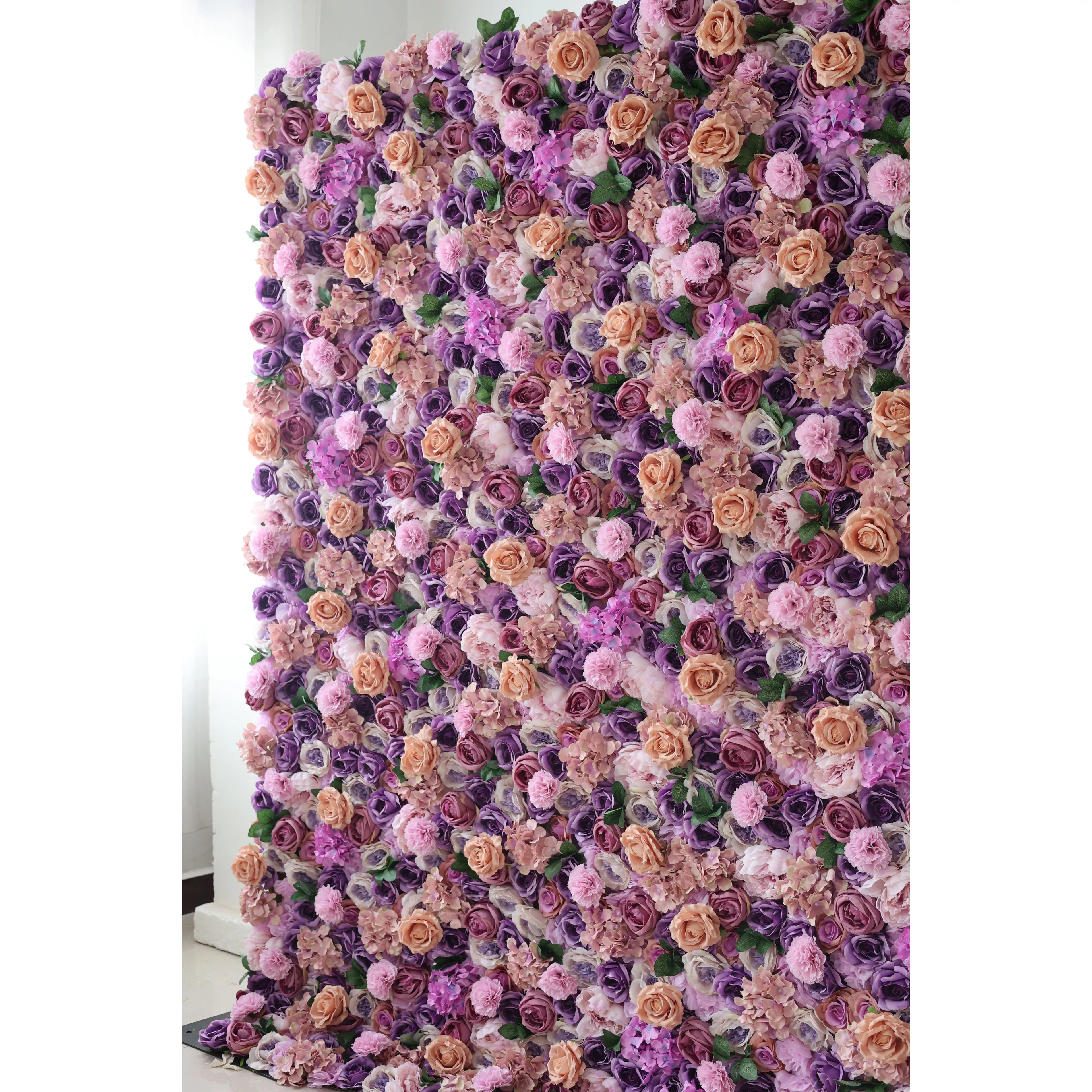This flower wall is a lush, vibrant display of artificial blooms. A harmonious blend of purple, lavender, and peach roses, plus delicate pink flowers, creates a dreamy, romantic texture. The dense arrangement and soft color palette make it perfect for weddings or elegant events, exuding charm and elegance.