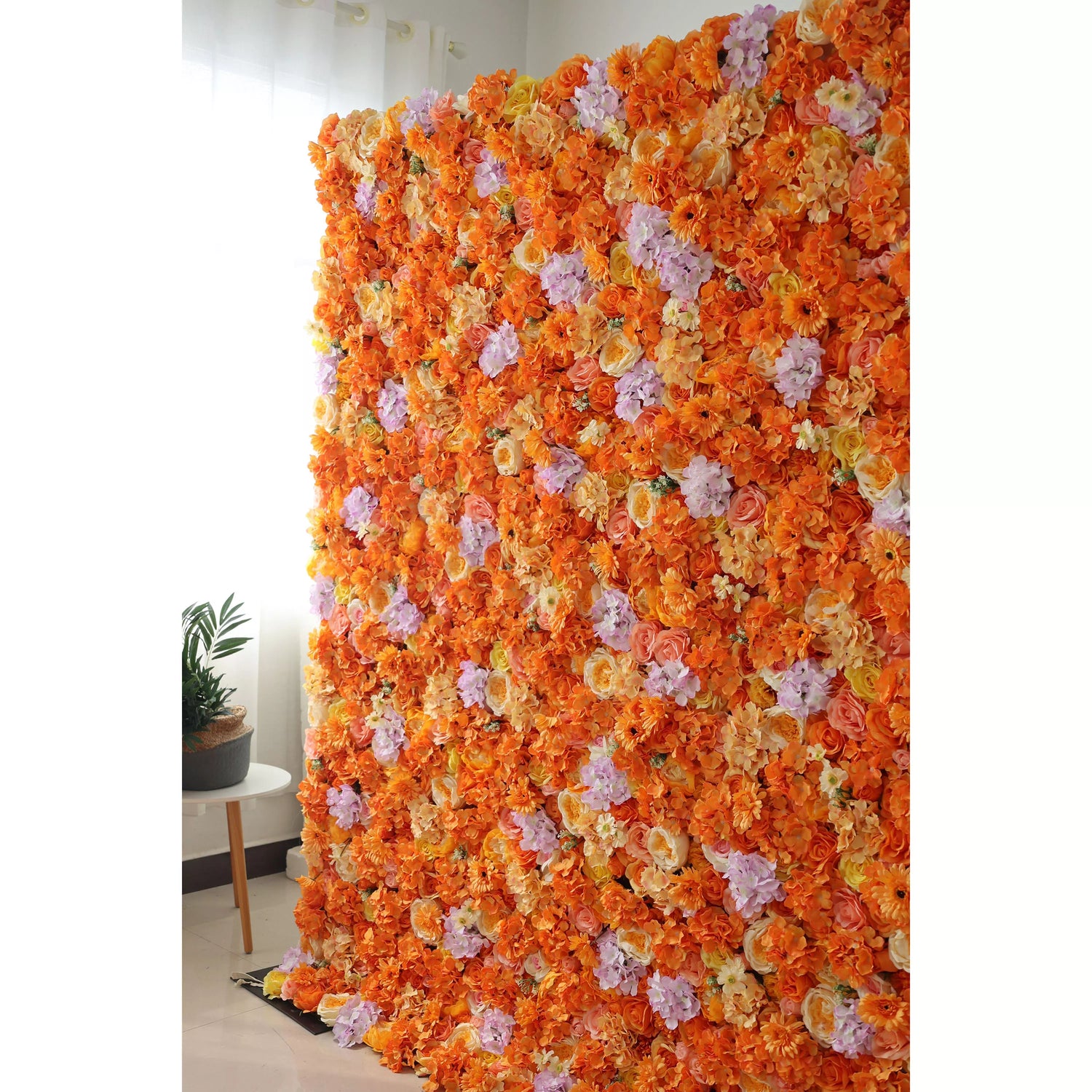 This image showcases a vibrant floral wall by Valar Flowers, set indoors. It&