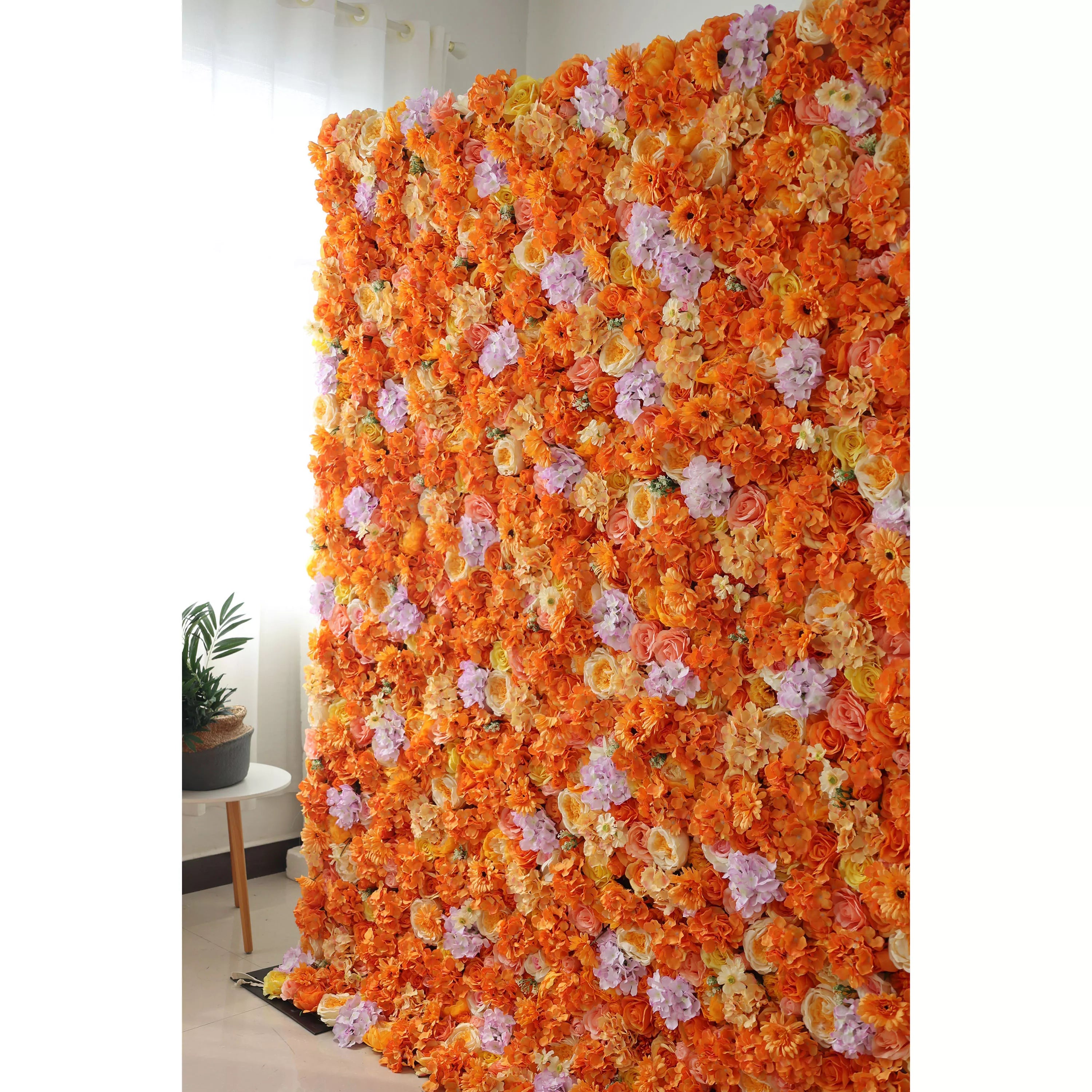 This image showcases a vibrant floral wall by Valar Flowers, set indoors. It&