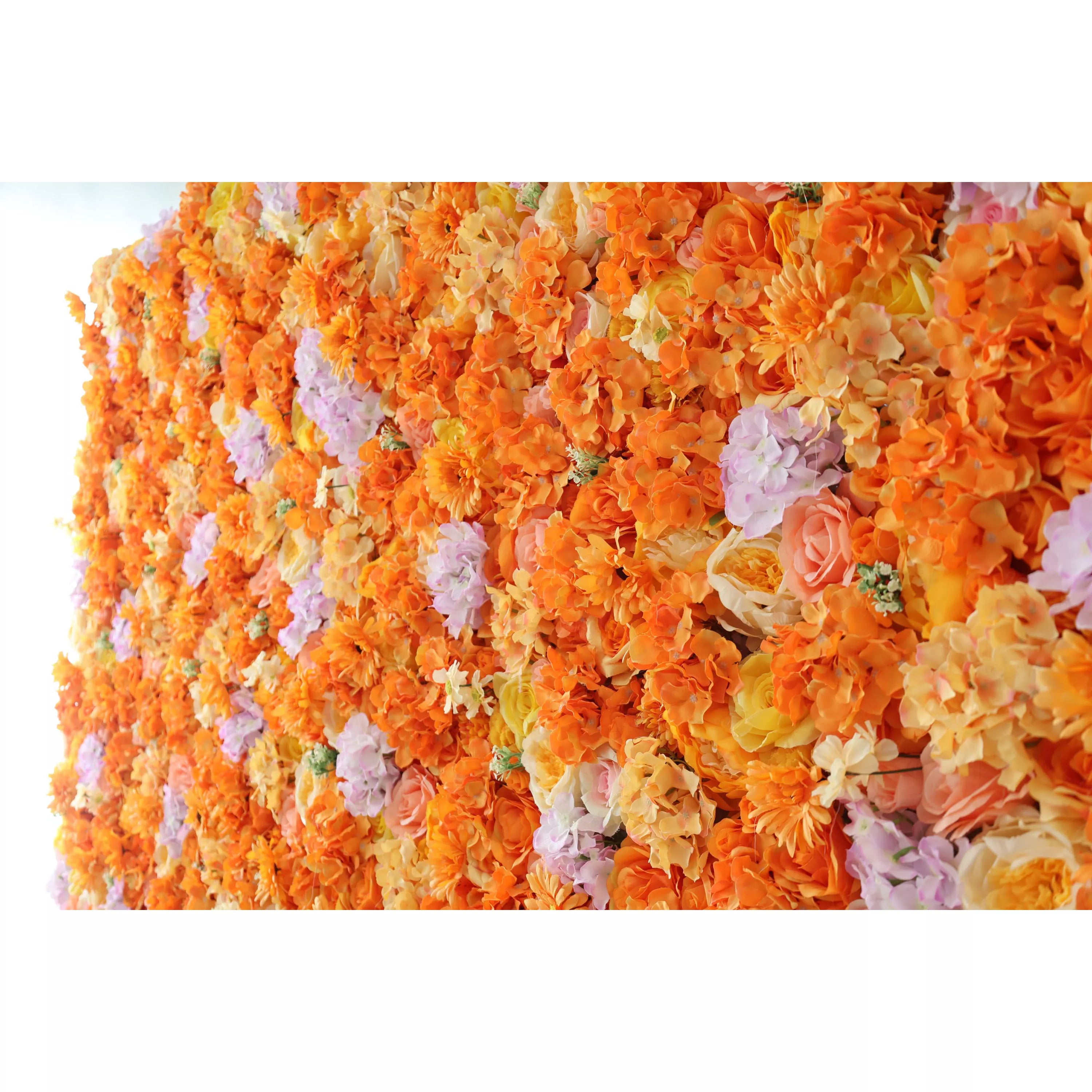 This image showcases a vibrant floral wall by Valar Flowers. Densely packed with artificial flowers, it features a rich palette of warm oranges, complemented by soft purples and creamy hues. The flowers, including roses and other blooms, create a lush, colorful, and visually striking display, exuding an elegant and lively charm, perfect for decorative use in events or as a stunning interior accent.