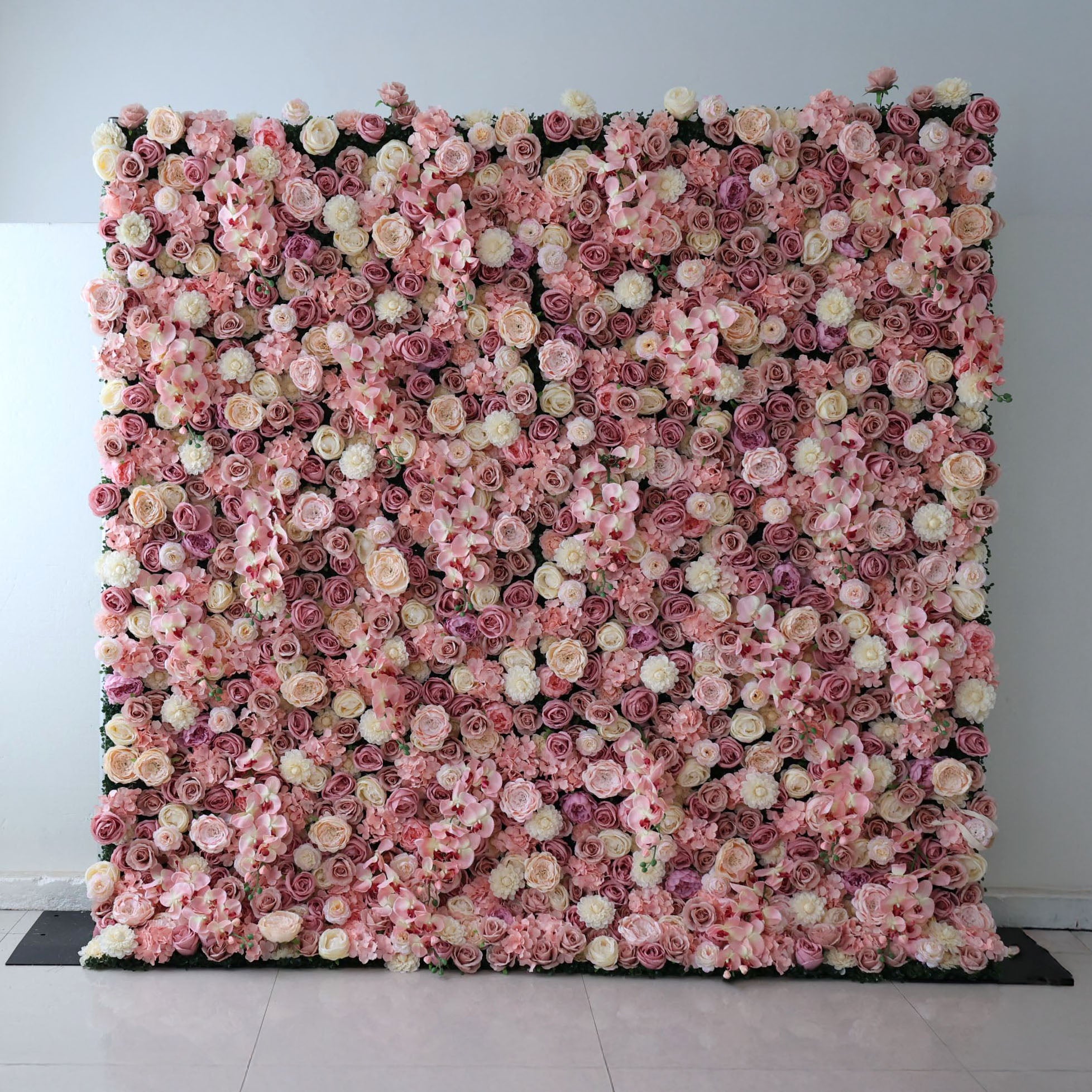 This is a full-size 8x8ft Valar Flowers premium blush pink artificial flower wall backdrop, featuring a lush, dense arrangement of lifelike roses, orchids, and hydrangeas in soft pink, champagne, and ivory tones, with subtle greenery accents. This high-quality, reusable floral display creates an elegant, romantic focal point, ideal for wedding backdrops, photo booths, bridal showers, baby showers, and luxury indoor event styling, delivering maintenance-free, long-lasting beauty for professional event decor.