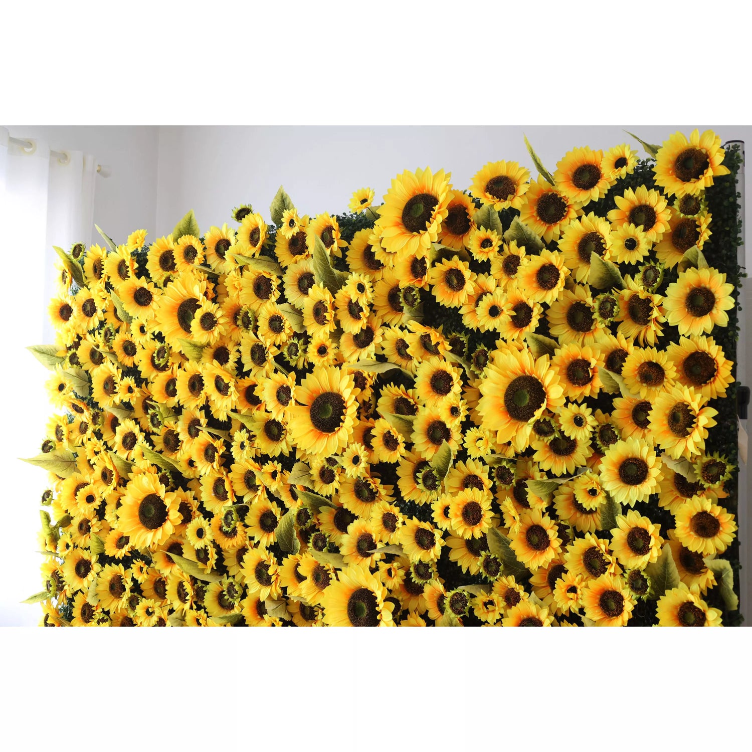 This flower wall is a vibrant, dense display of artificial sunflowers. Bright yellow petals, dark centers, and green leaves create a cheerful, sunny vibe. Perfect for events, it brings warmth and positivity, with varied bloom sizes adding depth. A lively, eye - catching backdrop for photos or decor.