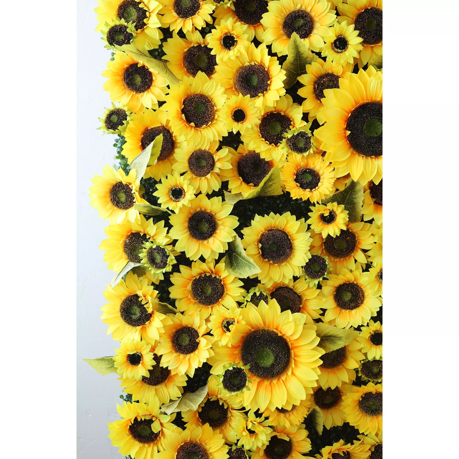 This flower wall is a vibrant, dense display of artificial sunflowers. Bright yellow petals, dark brown centers, and scattered green leaves create a cheerful, sunny vibe. Varying bloom sizes add depth, making it an eye - catching backdrop perfect for events, photos, or adding a touch of warmth and positivity to decor.