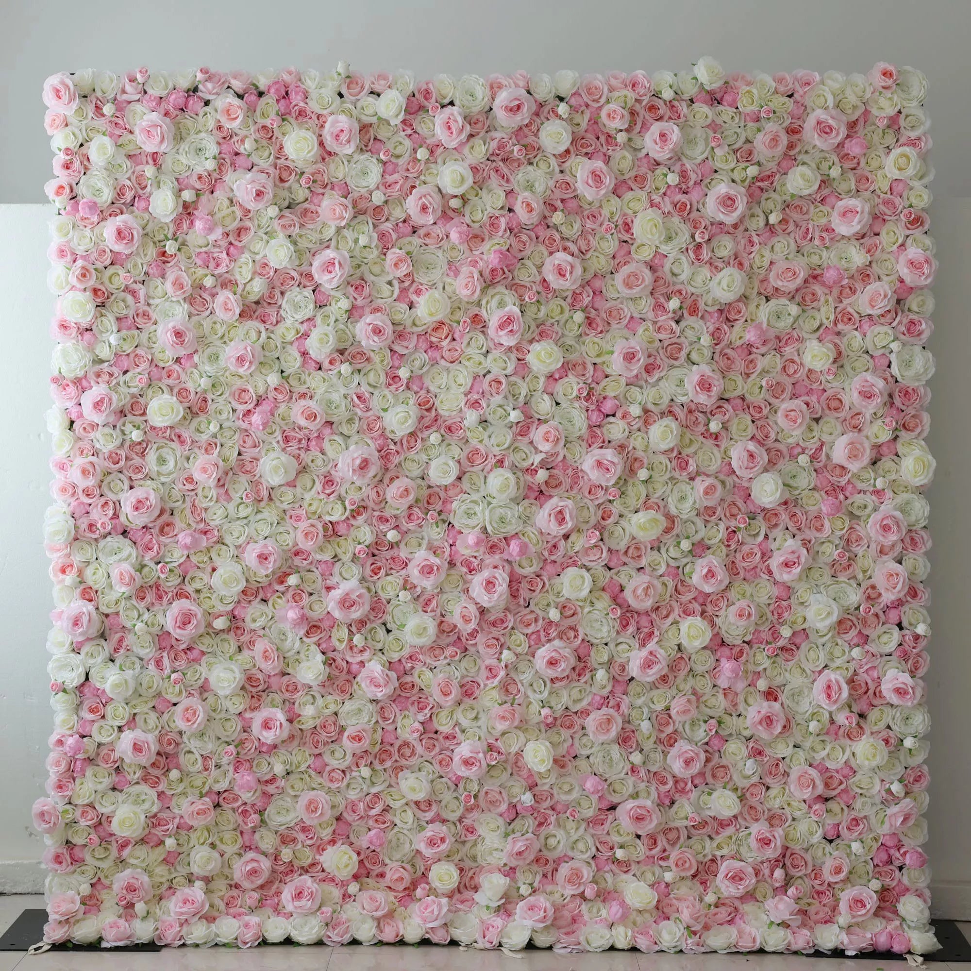 This is a large, rectangular artificial flower wall backdrop, densely covered with a lush mix of soft pink, white, and pale green roses and peonies. It stands upright indoors against a plain white wall, creating a romantic, elegant, and dreamy display perfect for weddings, photo shoots, or special events.