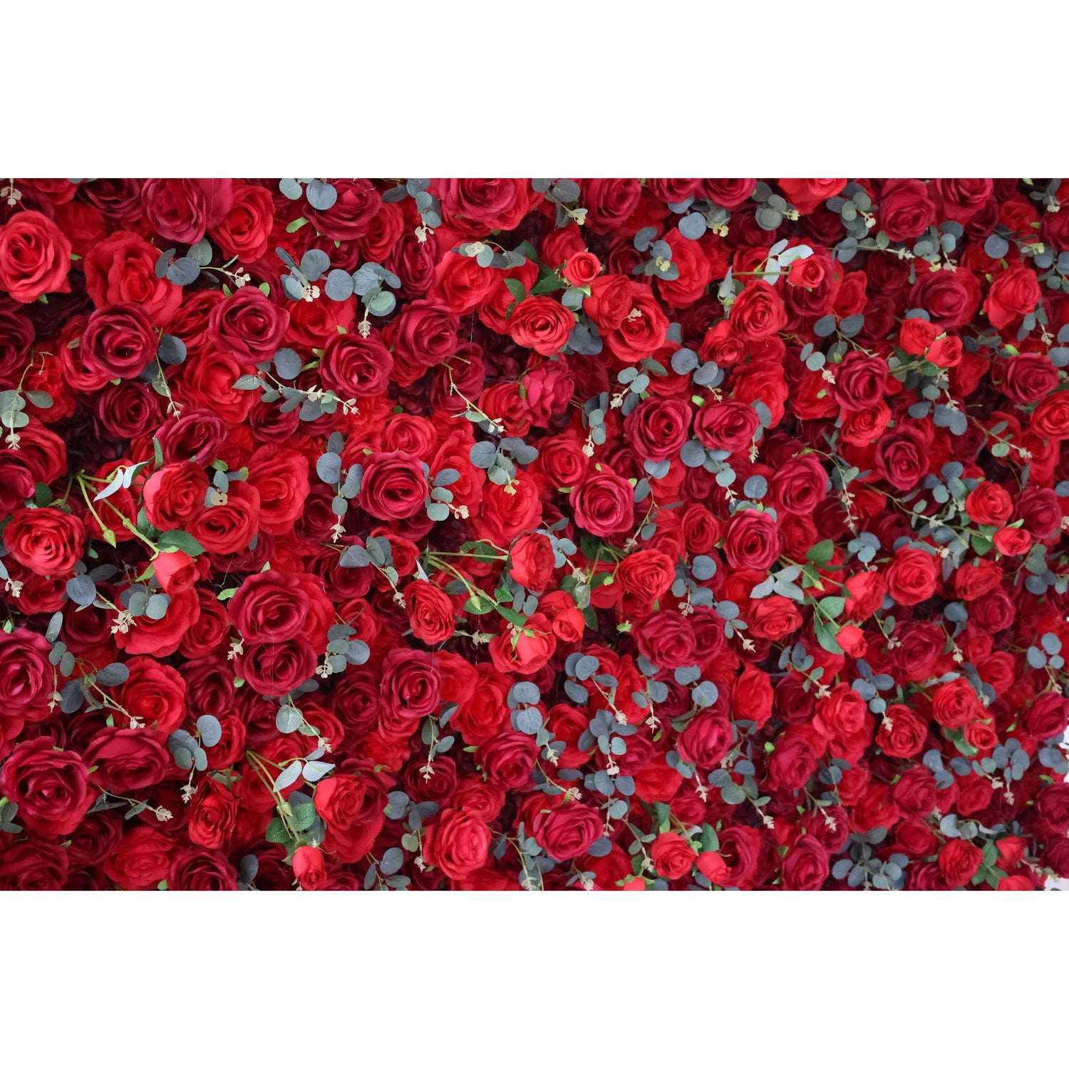 This flower wall is a lavish display of artificial red roses, interspersed with eucalyptus leaves. The dense, uniform arrangement creates a rich, passionate texture. Perfect for events needing a dramatic, romantic backdrop, exuding elegance and intensity. A striking centerpiece for weddings or celebrations.