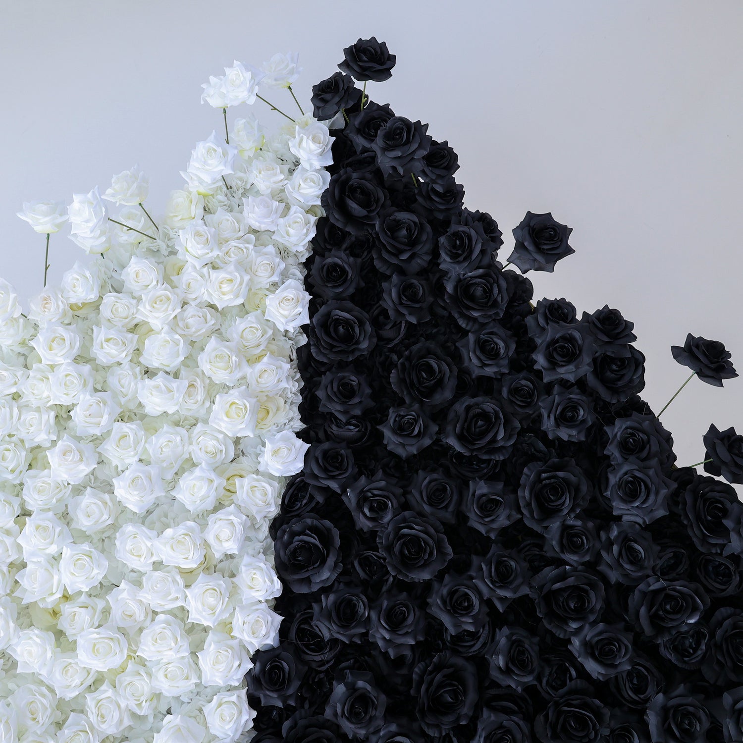 This photo presents a stunning floral wall by ValarFlowers, crafted from artificial roses. It&