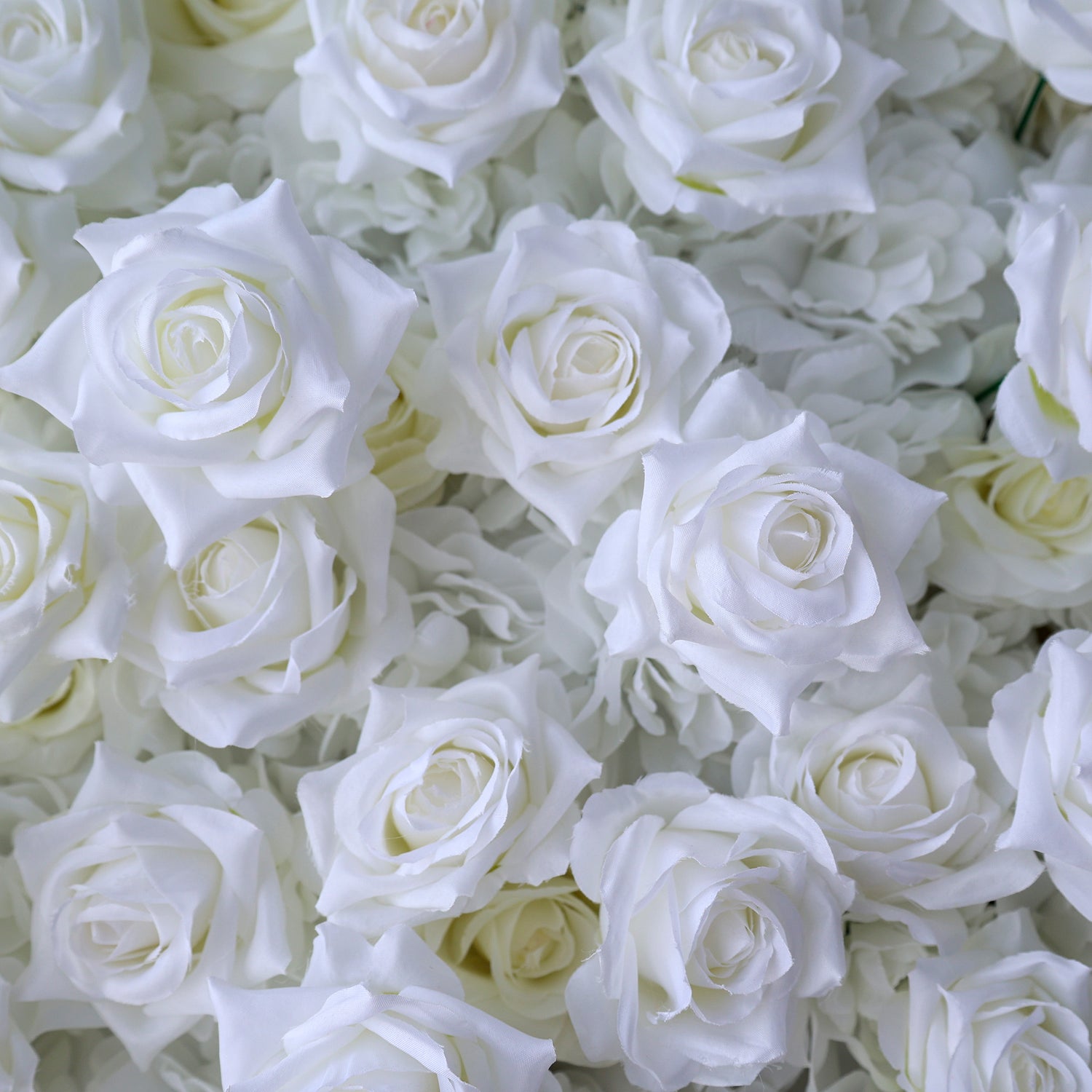 This photo showcases a lush arrangement of artificial white roses, likely from ValarFlowers. The blooms are densely packed, with petals crafted to mimic the delicate texture of real roses. The uniform white hue creates a serene, elegant aesthetic, perfect for weddings, events, or home decor. The realistic design offers long-lasting beauty, ideal for adding a touch of timeless sophistication to any setting.