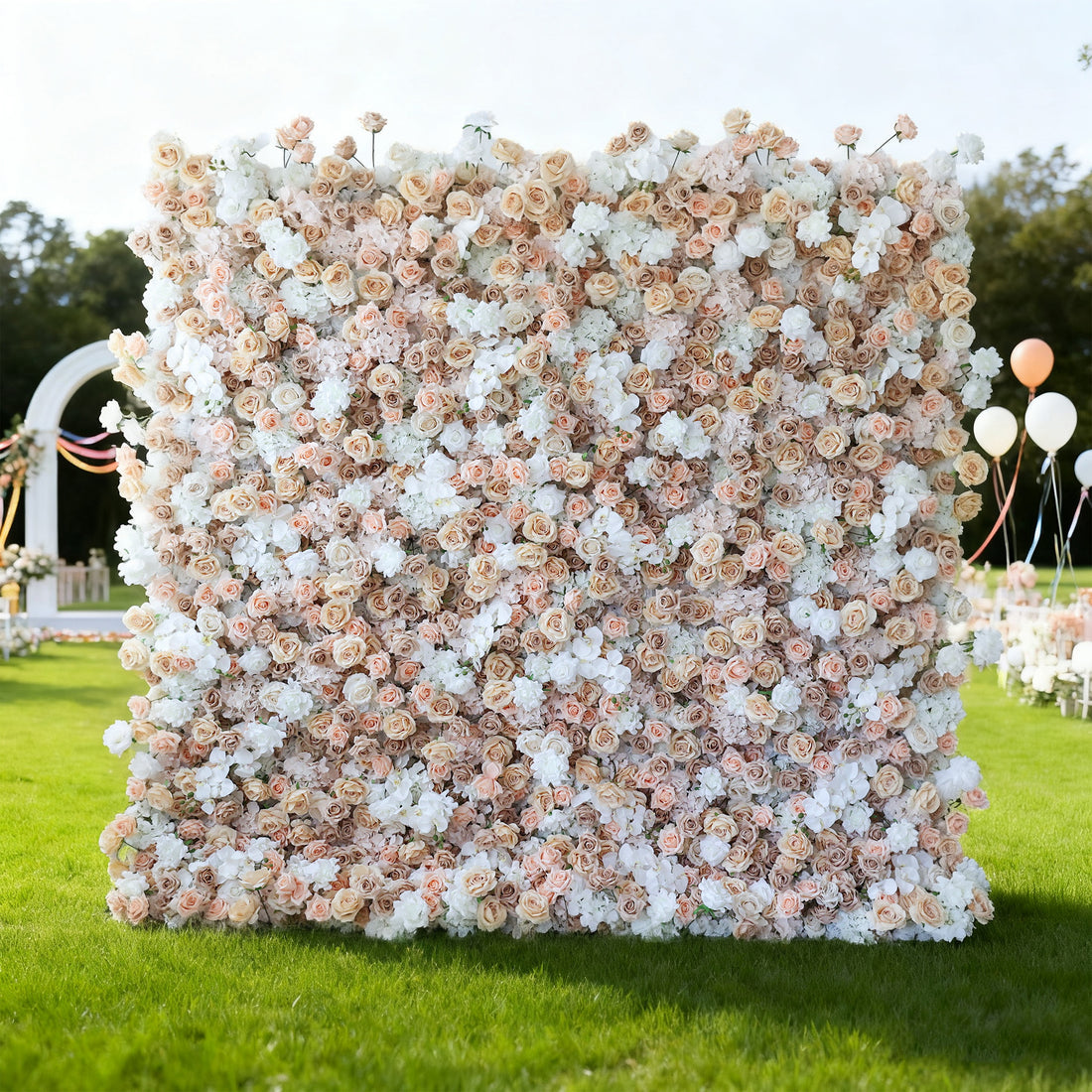 This image features a large, square floral wall outdoors on a lush green lawn. It&