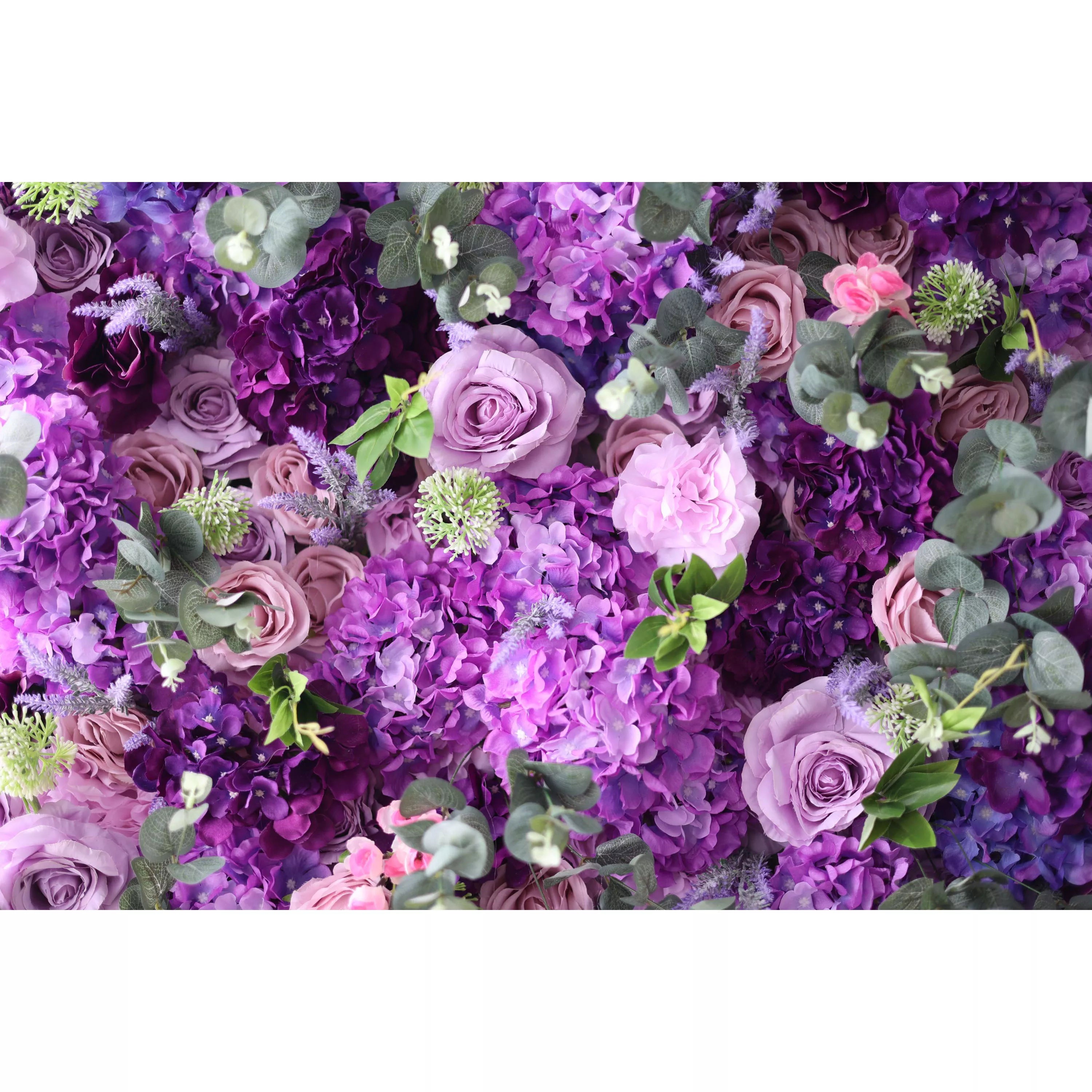 This image presents a lush arrangement of artificial flowers in various shades of purple, from deep violet to soft lavender, along with some pink blooms. There are also green leaves interspersed. The dense cluster of petals creates a rich, vibrant, and elegant visual effect, exuding a sense of luxury and natural beauty, perfect for decorative purposes in events or as a striking backdrop.