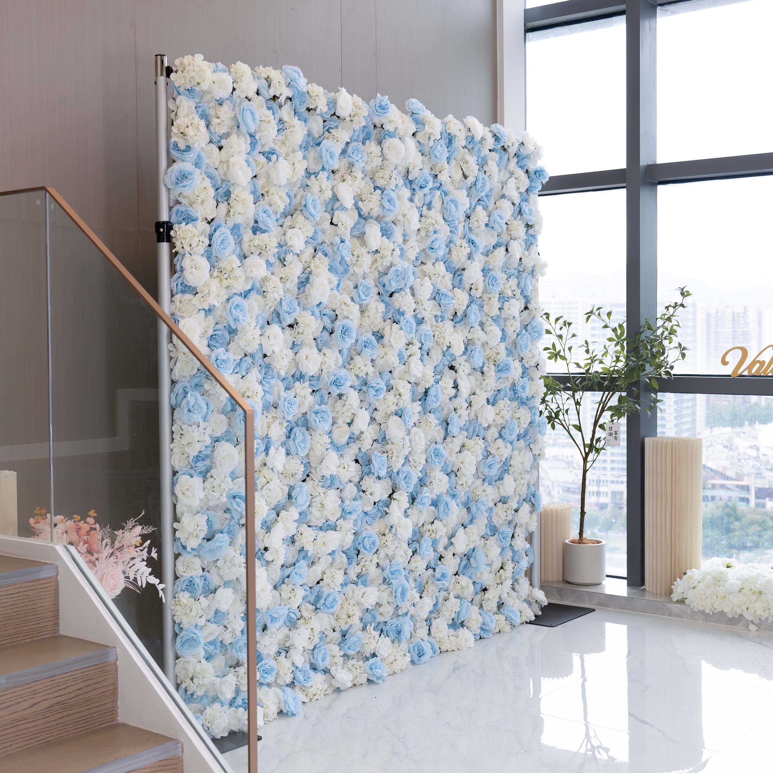 The ValarFlowers artificial flower wall is a perfect choice for weddings. It features a beautiful blend of white and blue flowers, creating a romantic and elegant backdrop for the special day.