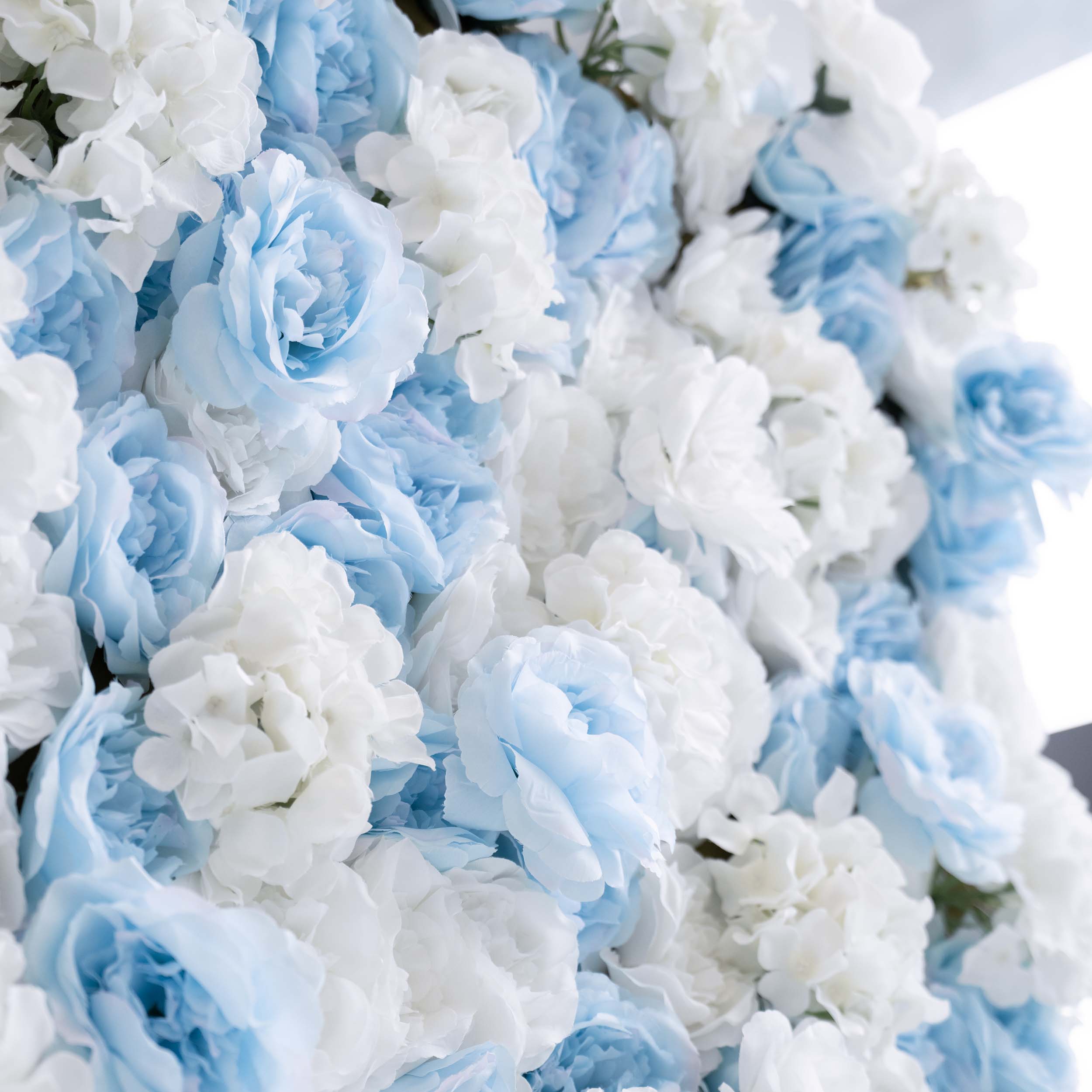 The ValarFlowers artificial flower wall is ideal for weddings. It features a stunning blend of blue and white flowers, creating a romantic and elegant backdrop for the big day.