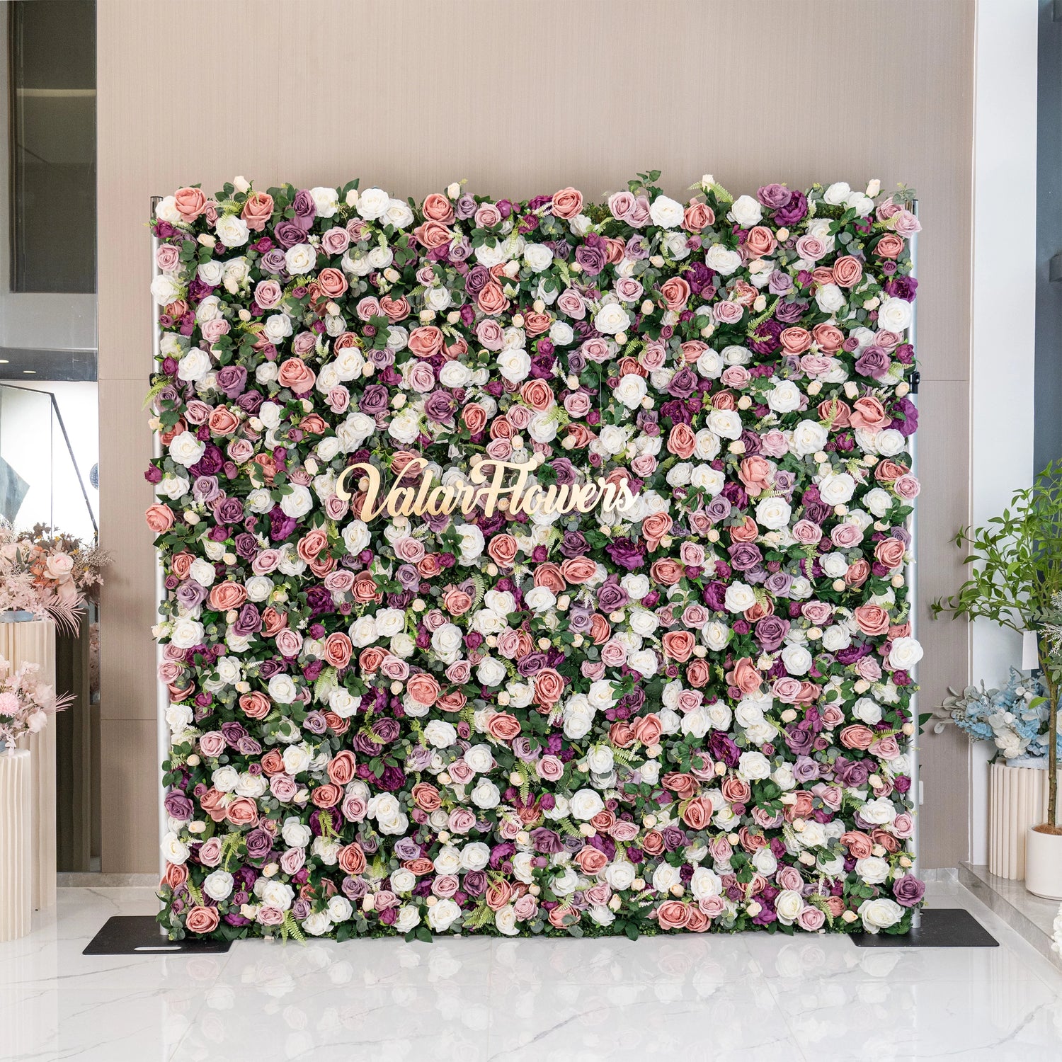 This floral wall boasts a vibrant mix of pink, purple, and white roses. Ideal for events, it adds a romantic and lush backdrop with its rich colors and dense arrangement, enhancing the elegance of any sophisticated setting.